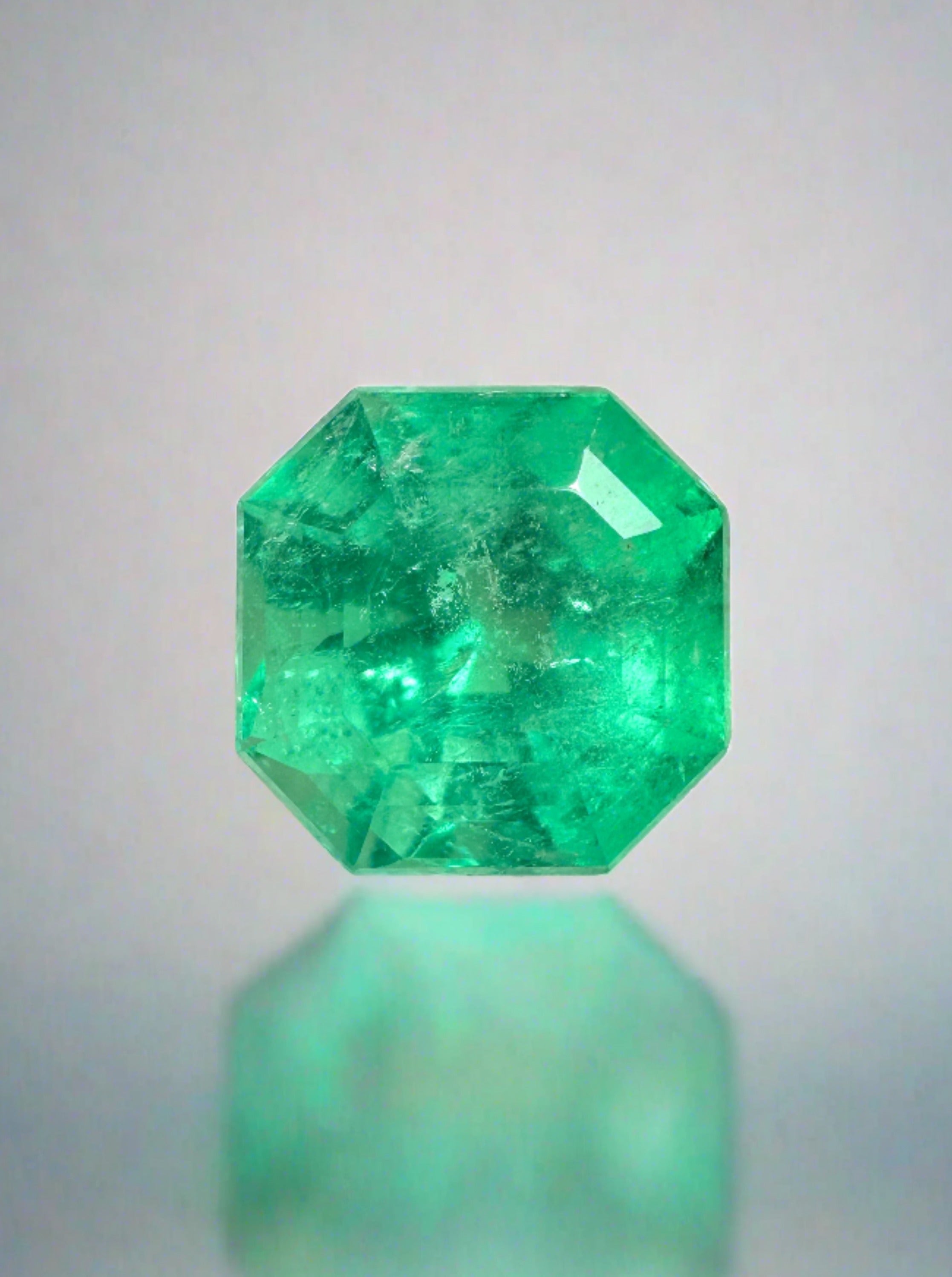 Luminous 3.68 Carat natural Colombian emerald in Asscher cut with clipped corners, displayed as a loose gemstone.
