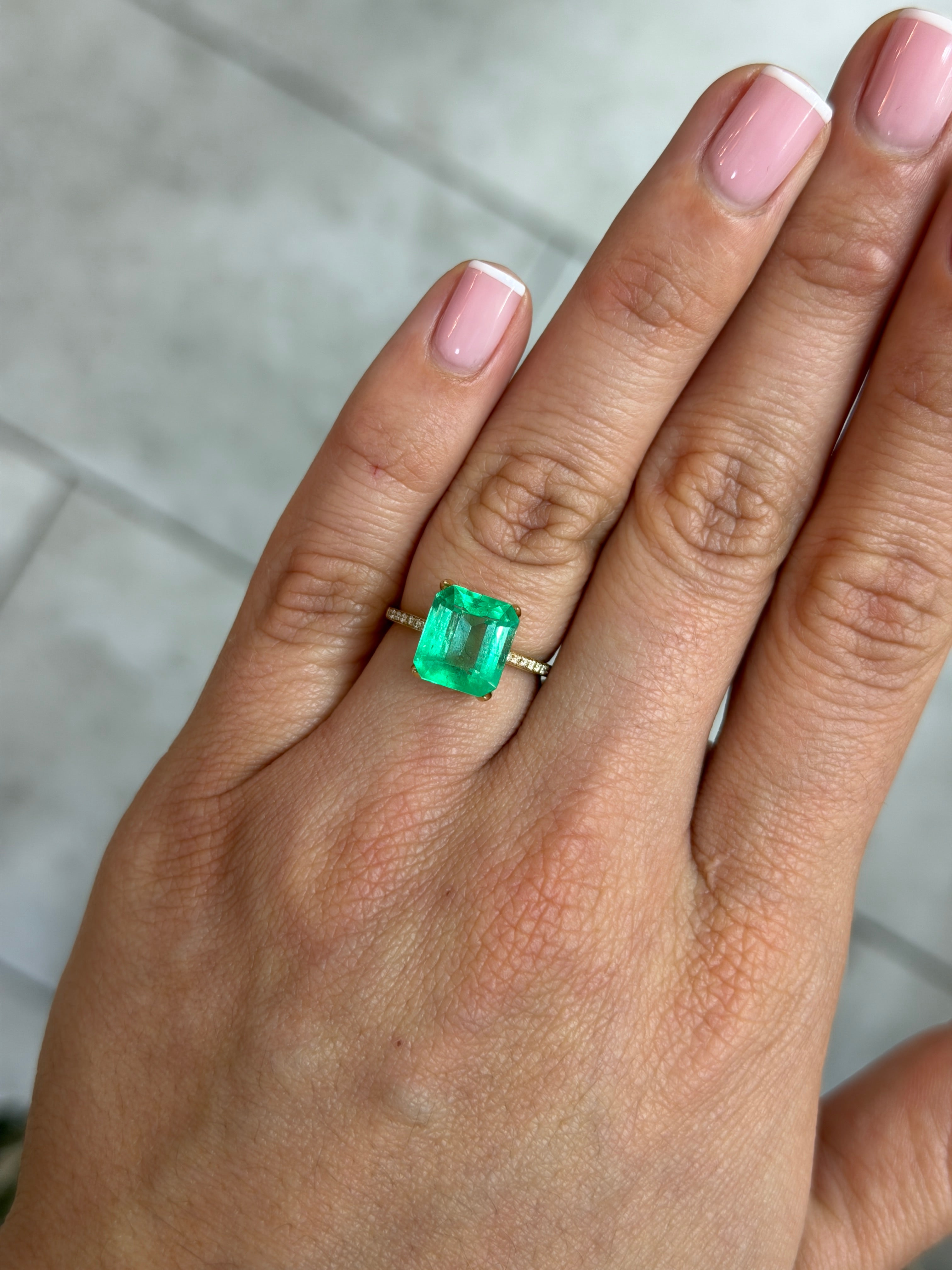 Natural 3.72 carat spring green Colombian emerald loose gemstone in an emerald cut, showcasing vibrant color and clarity.