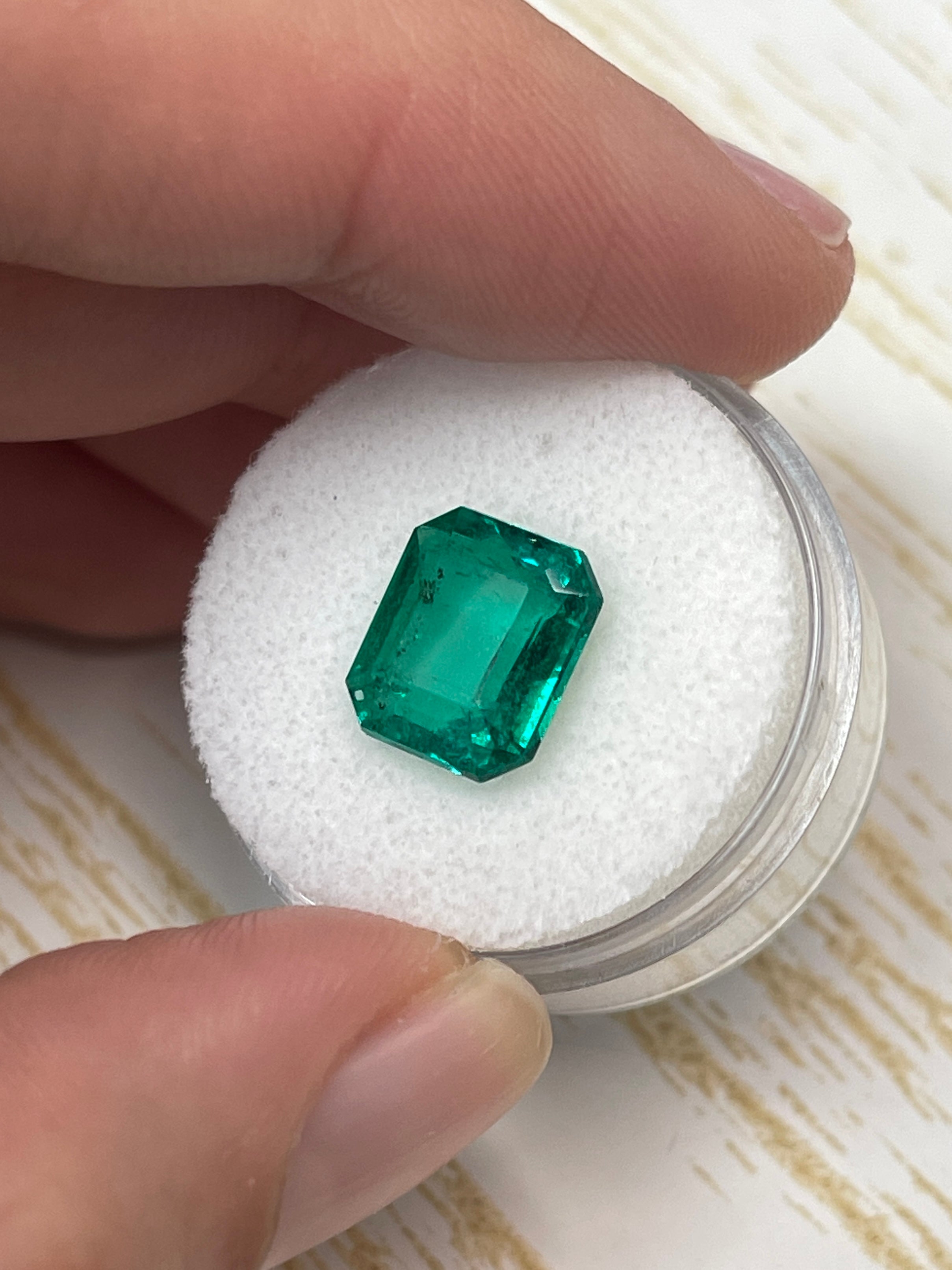 AAA+ 3.72 carat natural Colombian emerald cut green loose gemstone with freckles from JR Colombian Emeralds, 11x9 mm size.