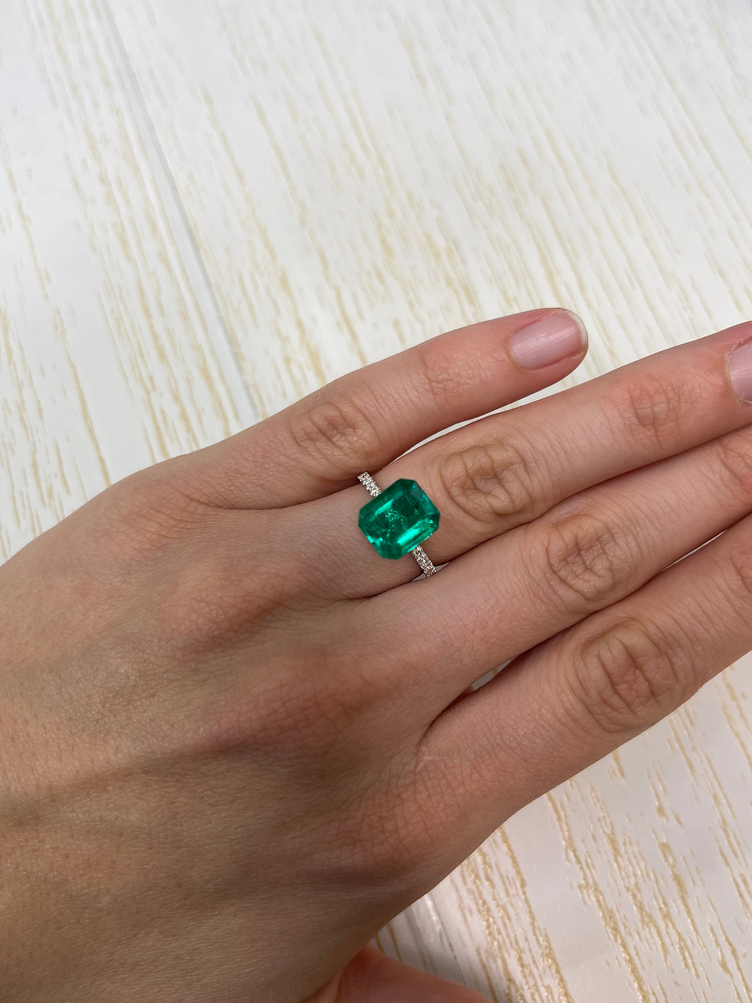 3.72 carat AAA+ green Colombian emerald loose gemstone in an 11x9 mm emerald cut with natural freckled appearance