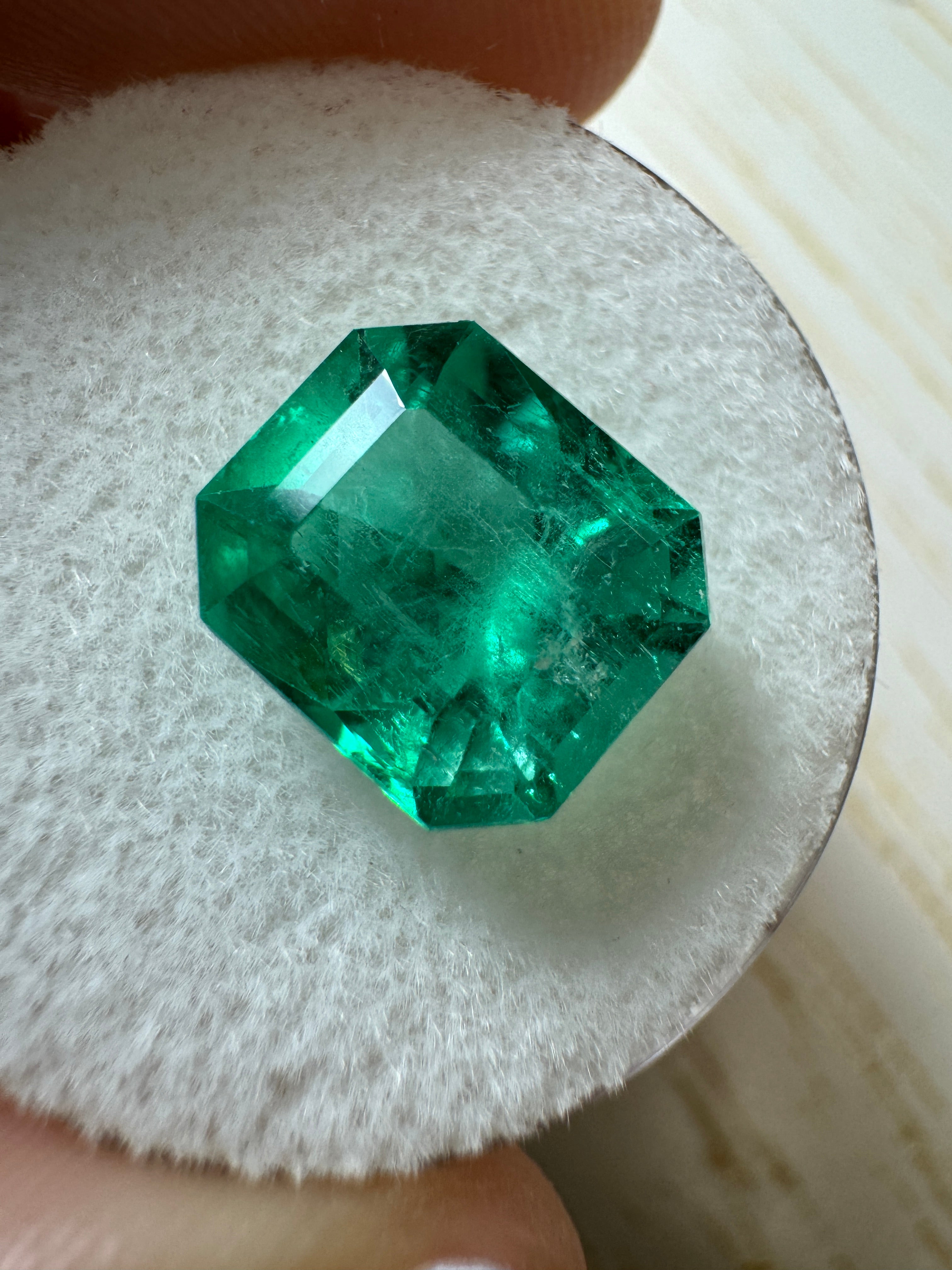 Glowing 3.80 carat natural Colombian emerald loose gemstone in emerald cut, showcasing vibrant green color and clarity.