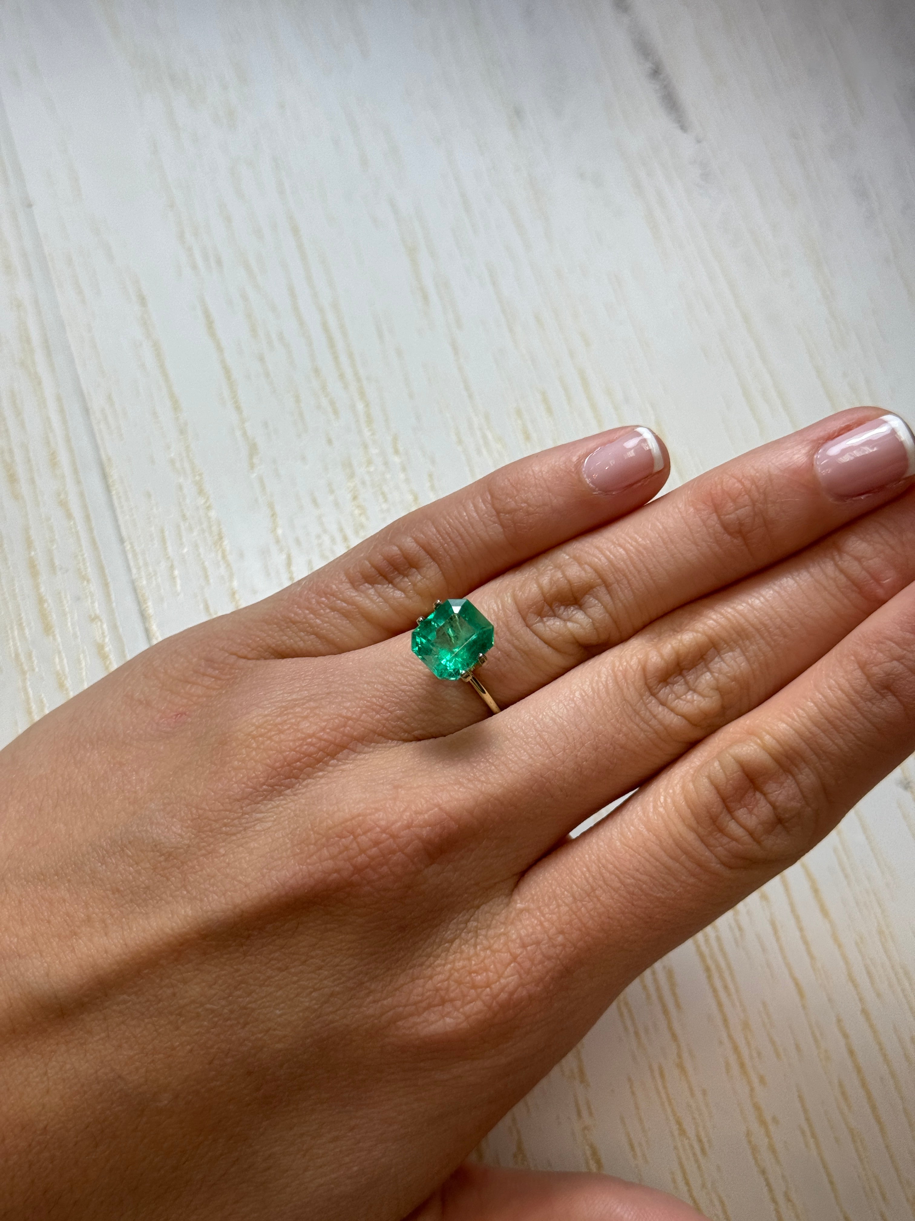 Natural 3.80 carat glowing green Colombian emerald loose gemstone in an emerald cut, showing vibrant color and clarity.