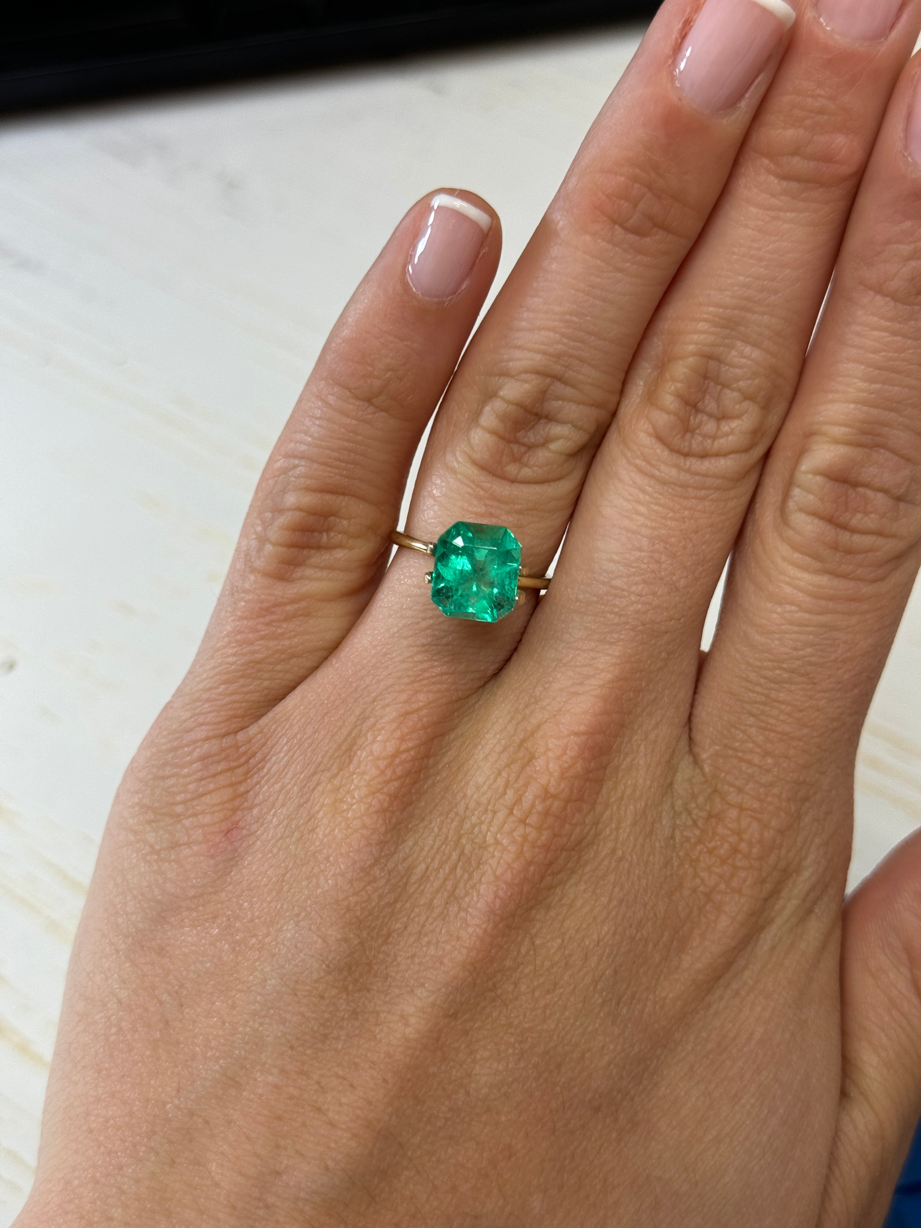 Glowing 3.80 carat natural Colombian emerald loose gemstone in emerald cut, with rich green color and clarity.
