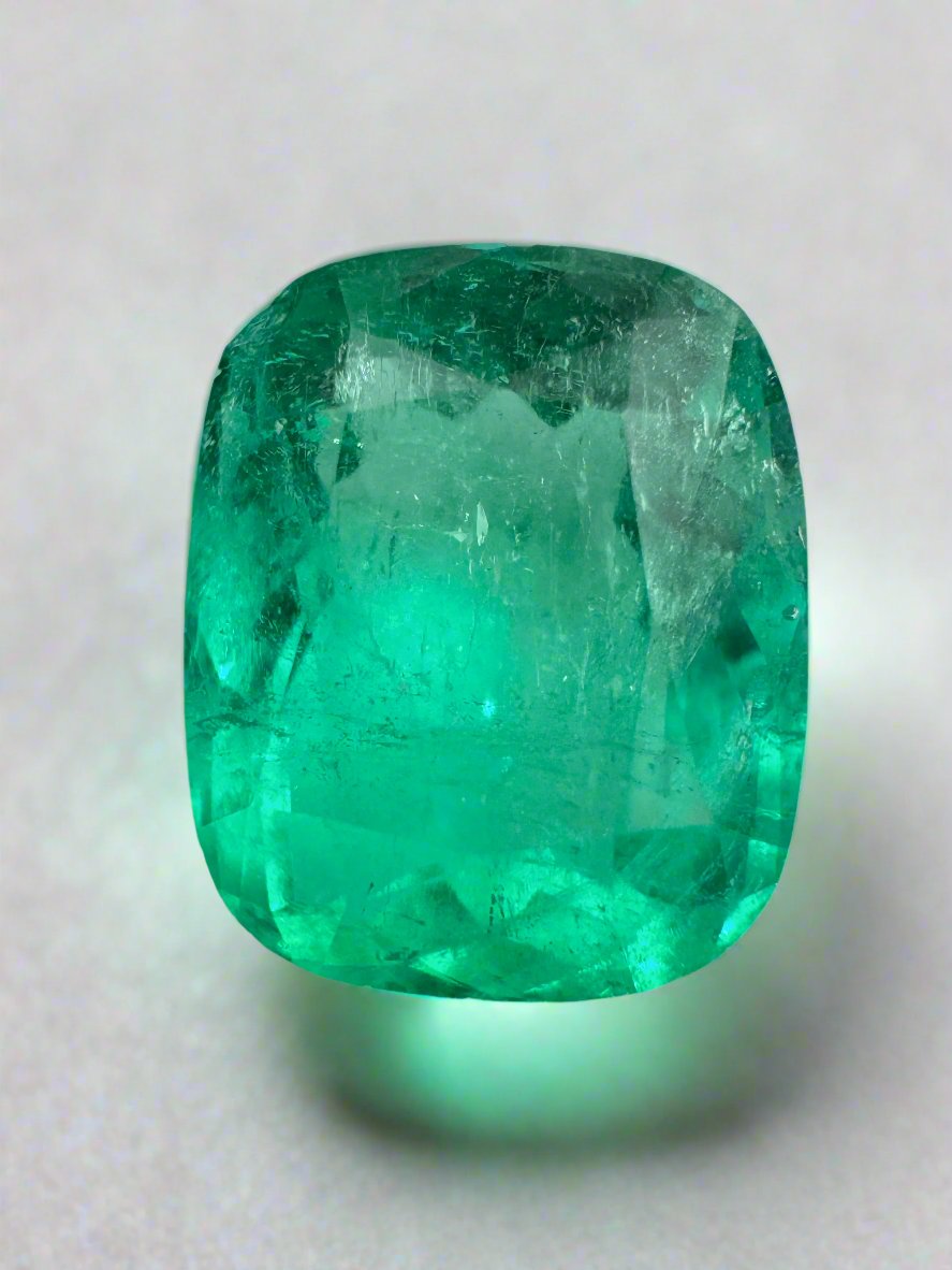 3.85 carat medium green Colombian emerald loose cushion cut by JR Colombian Emeralds, showcasing vibrant natural color and clarity.