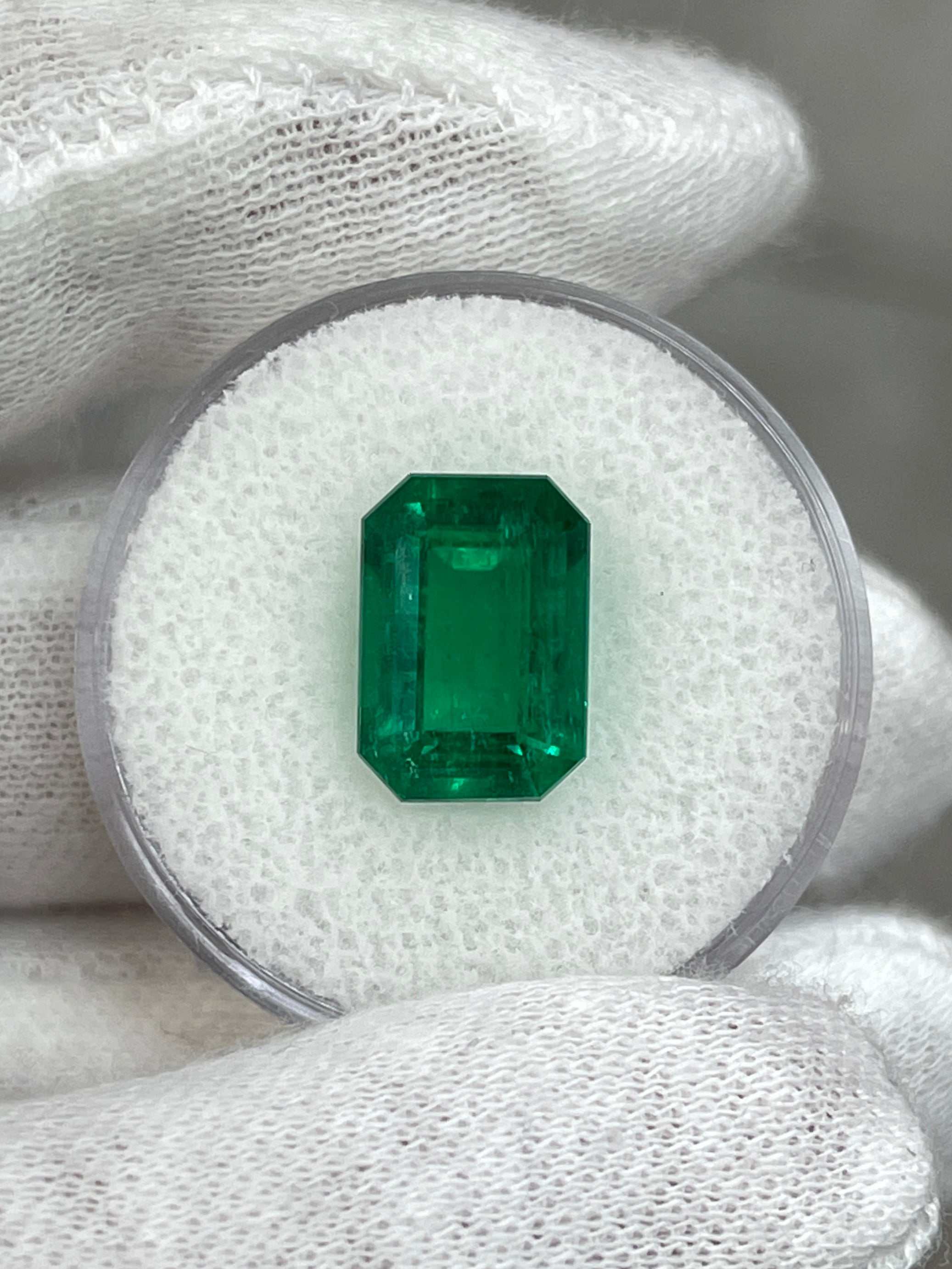 Vivid green 3.95-carat Colombian emerald cut loose emerald with GIA certification, showcasing its clarity and vibrant color.