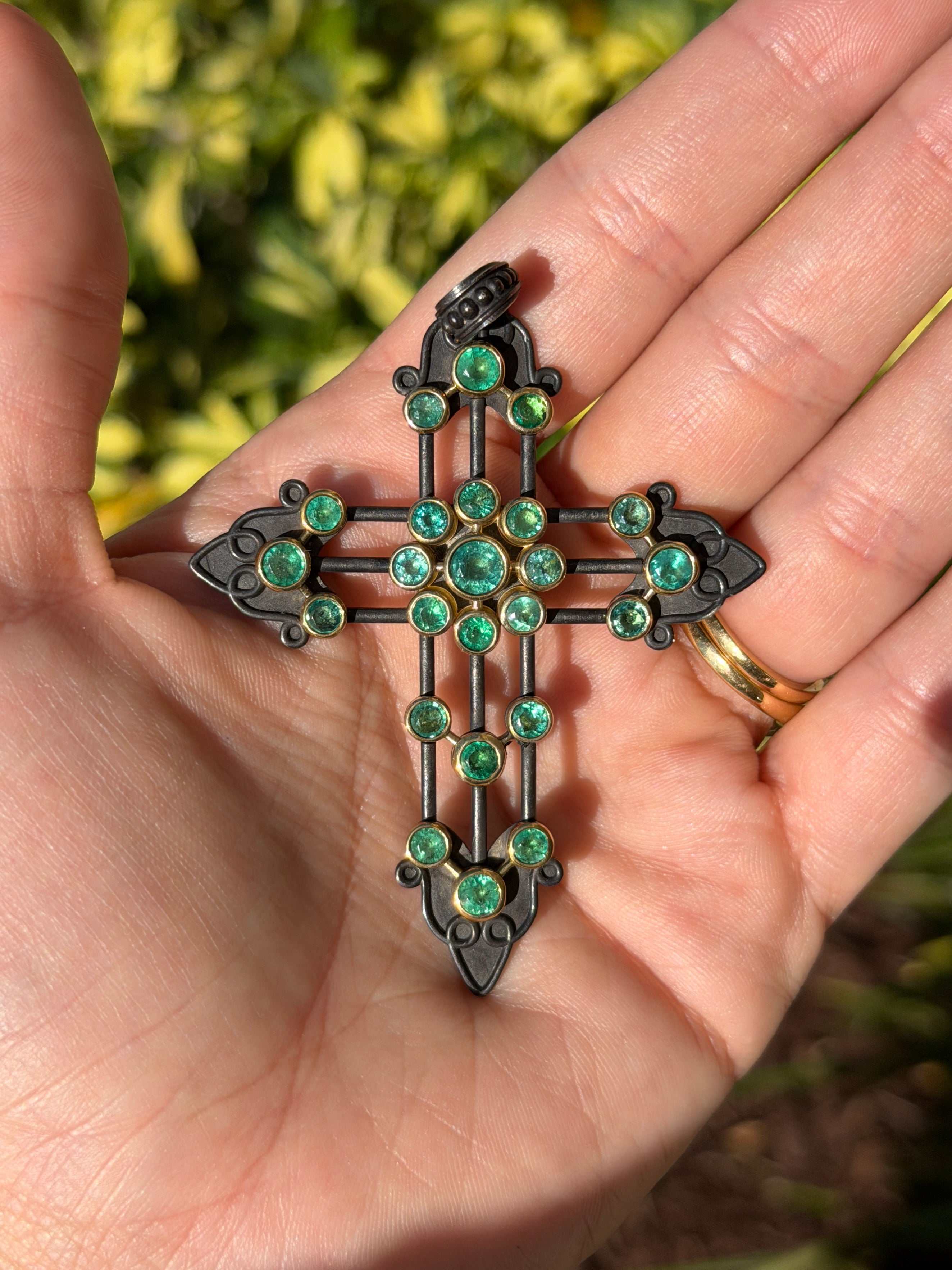Gothic emerald crucifix pendant with 3.95 carats of Colombian emeralds in 14K gold and blackened silver by JR Colombian Emeralds.