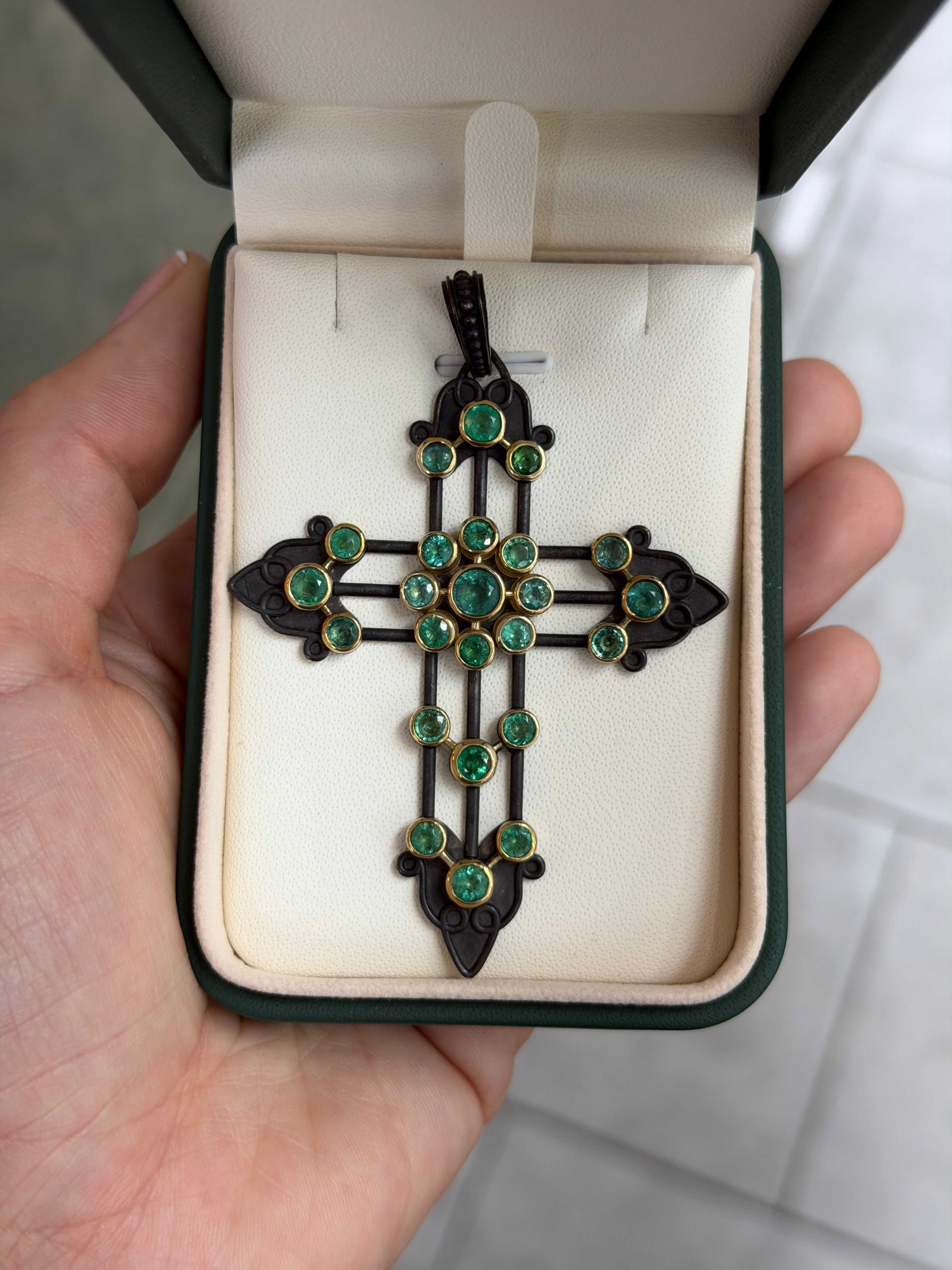 Gothic emerald crucifix pendant with 3.95tcw gemstones in 14K gold and blackened silver, featuring detailed religious design.