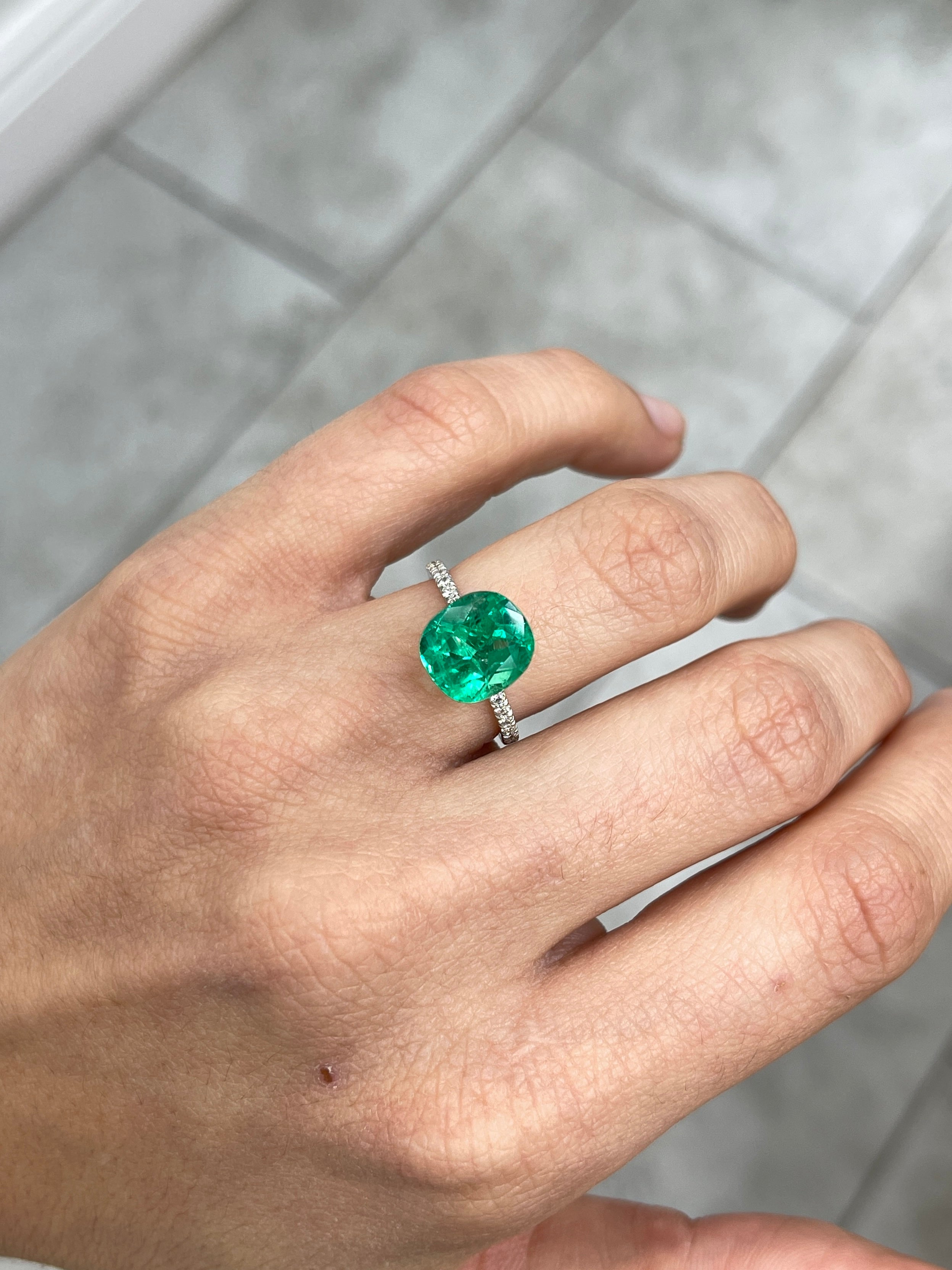 4.96 carat freckled vivid bluish green cushion cut loose emerald by JR Colombian Emeralds, showcasing rich color and natural inclusions.