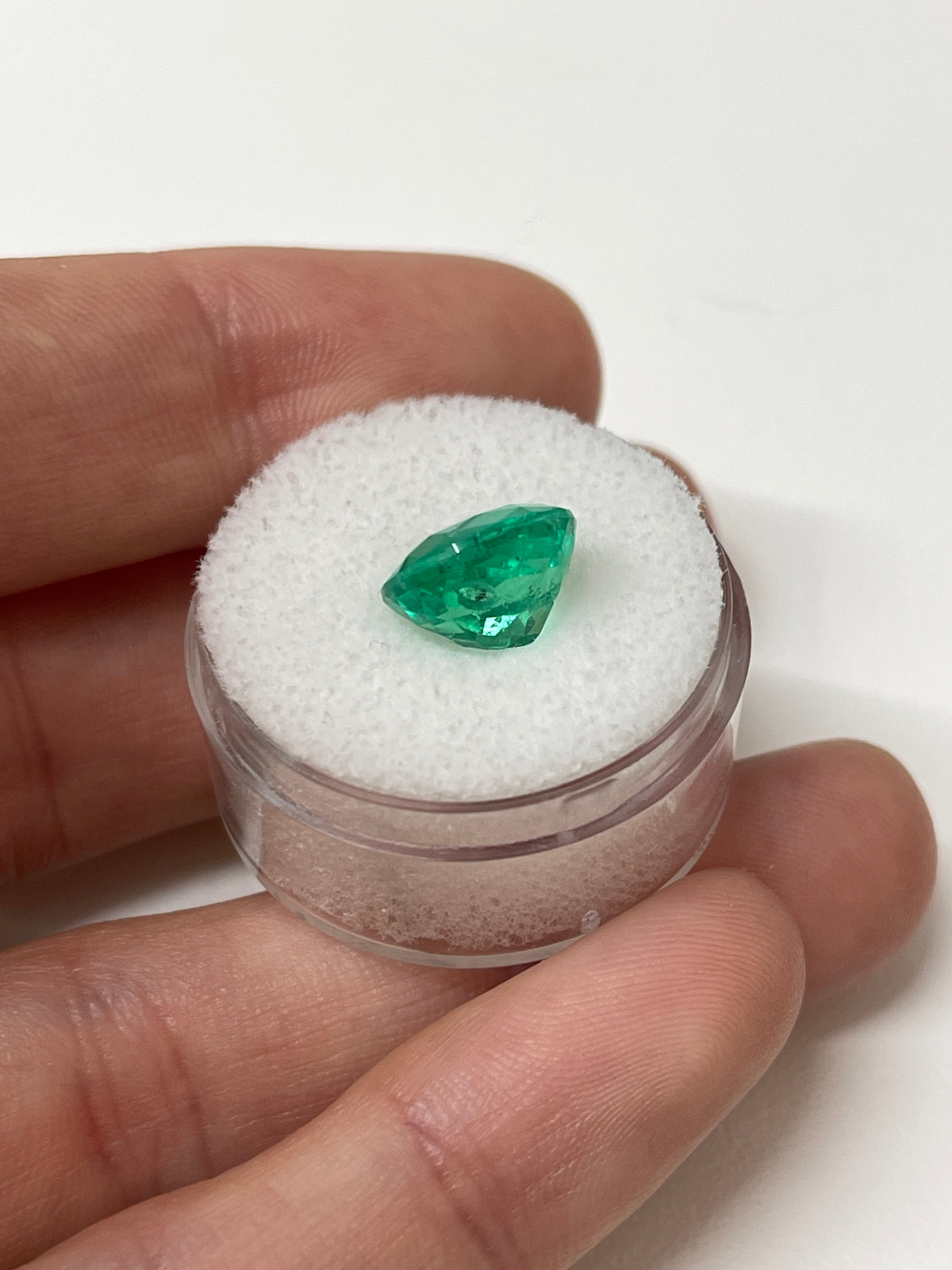 4.96 carat freckled vivid bluish-green cushion cut loose emerald from JR Colombian Emeralds showcasing natural inclusions and rich color.