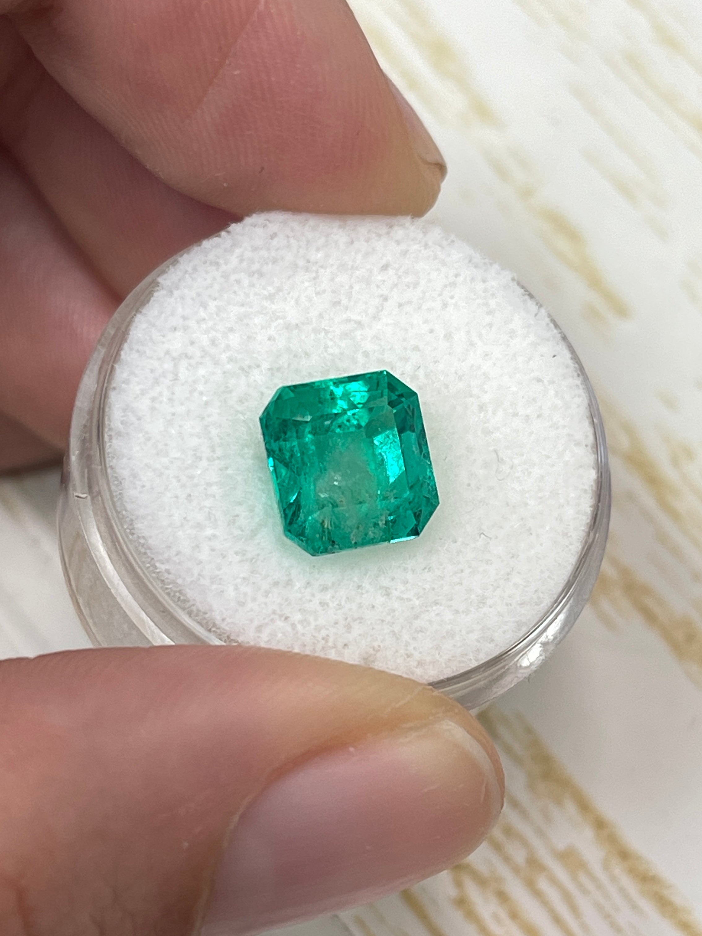 Vivid 4.22 carat natural Colombian Muzo emerald in a 9x9mm Asscher cut, showcasing deep green color and clarity.