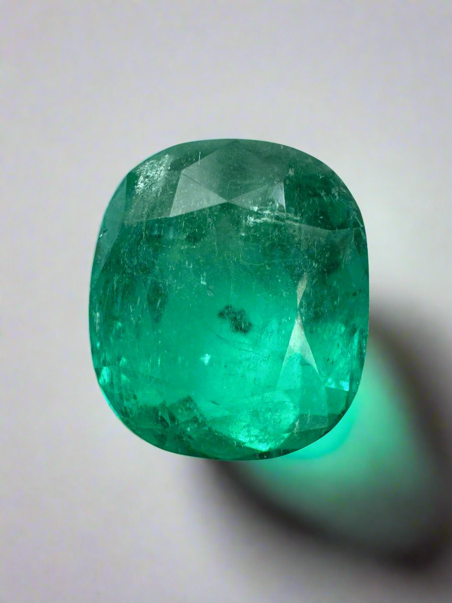 Deep green 4.37 carat cushion cut Colombian emerald with natural freckles, loose gemstone from JR Colombian Emeralds.
