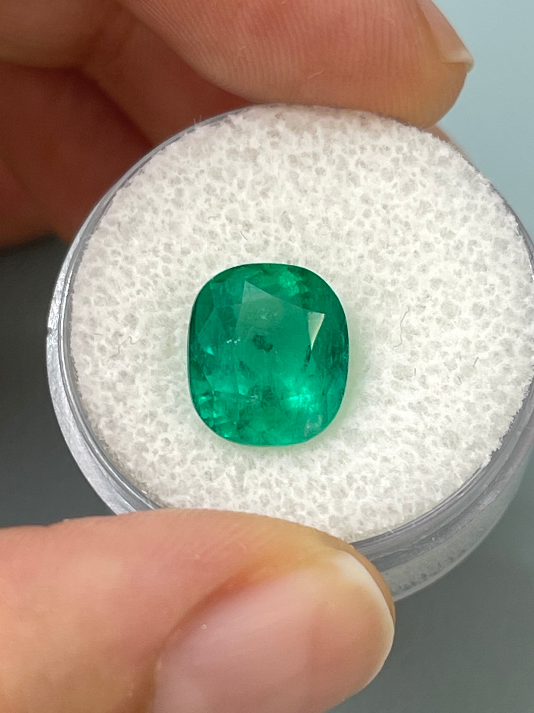 Natural deep green Colombian emerald, 4.37 carats, cushion cut with natural freckles, from JR Colombian Emeralds.