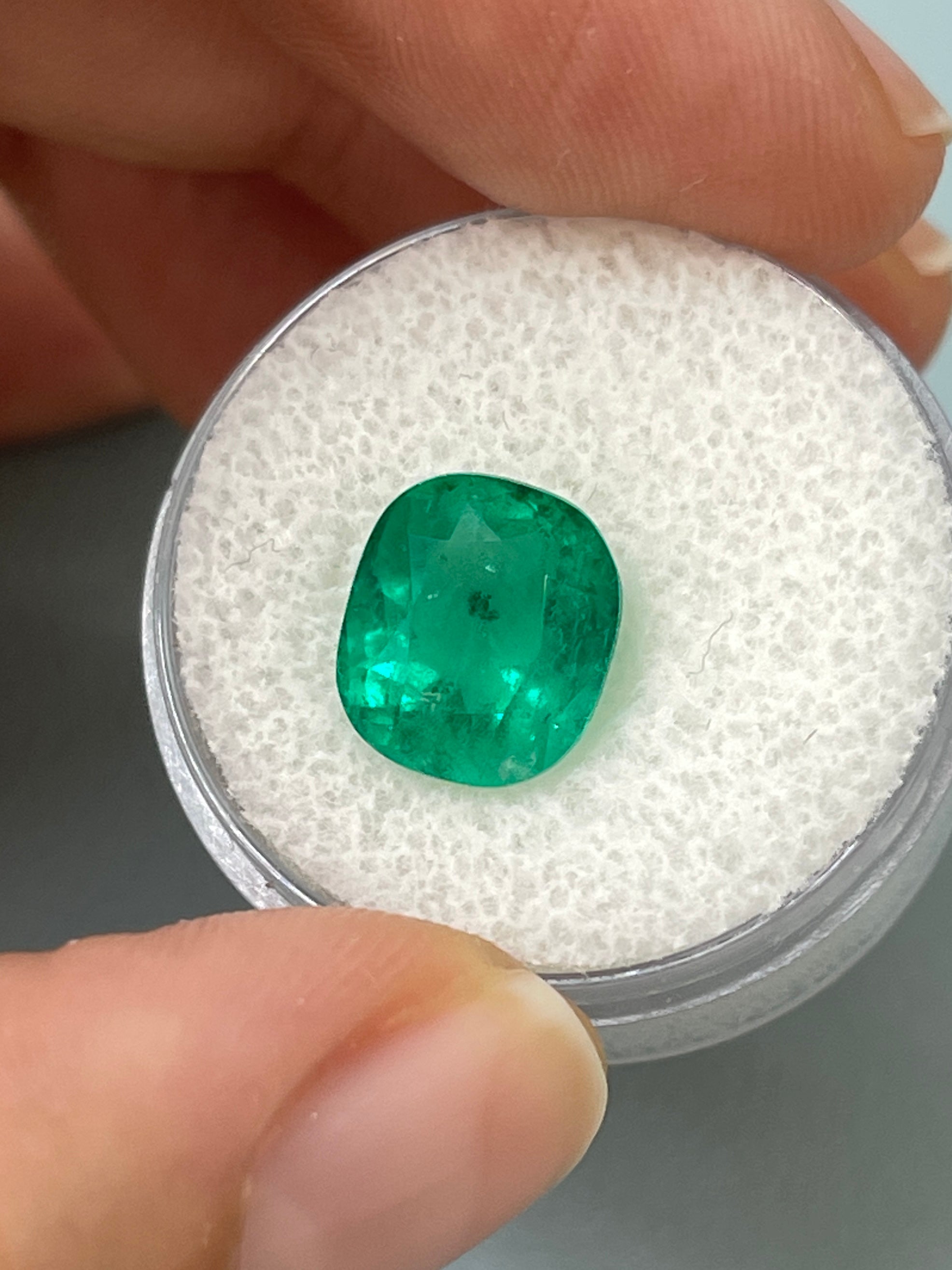 Deep green 4.37 carat natural Colombian emerald loose cushion cut gem with natural freckles, from JR Colombian Emeralds.
