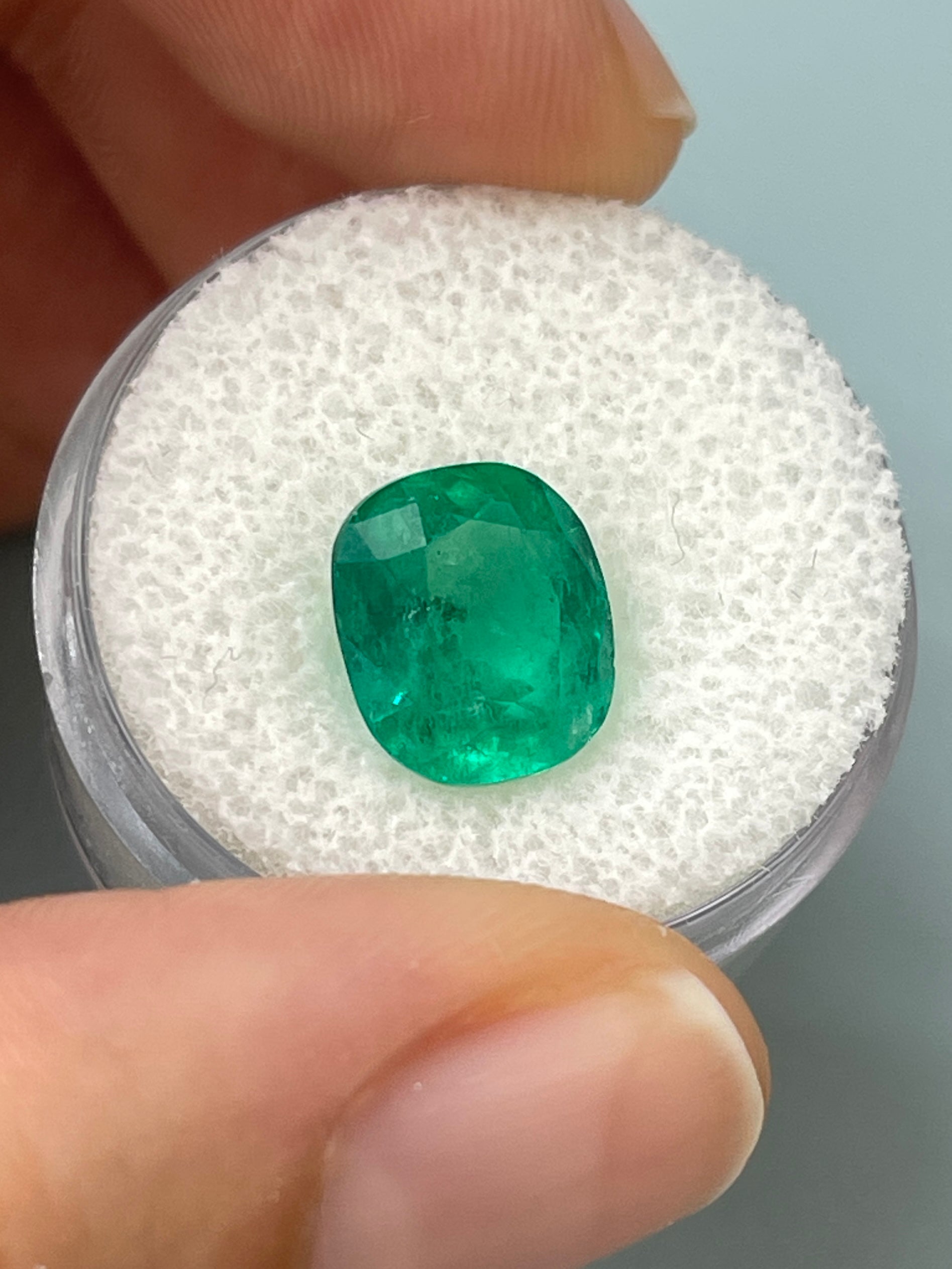 Natural deep green 4.37 carat Colombian emerald loose gemstone, cushion cut with natural freckled appearance, from JR Colombian Emeralds.