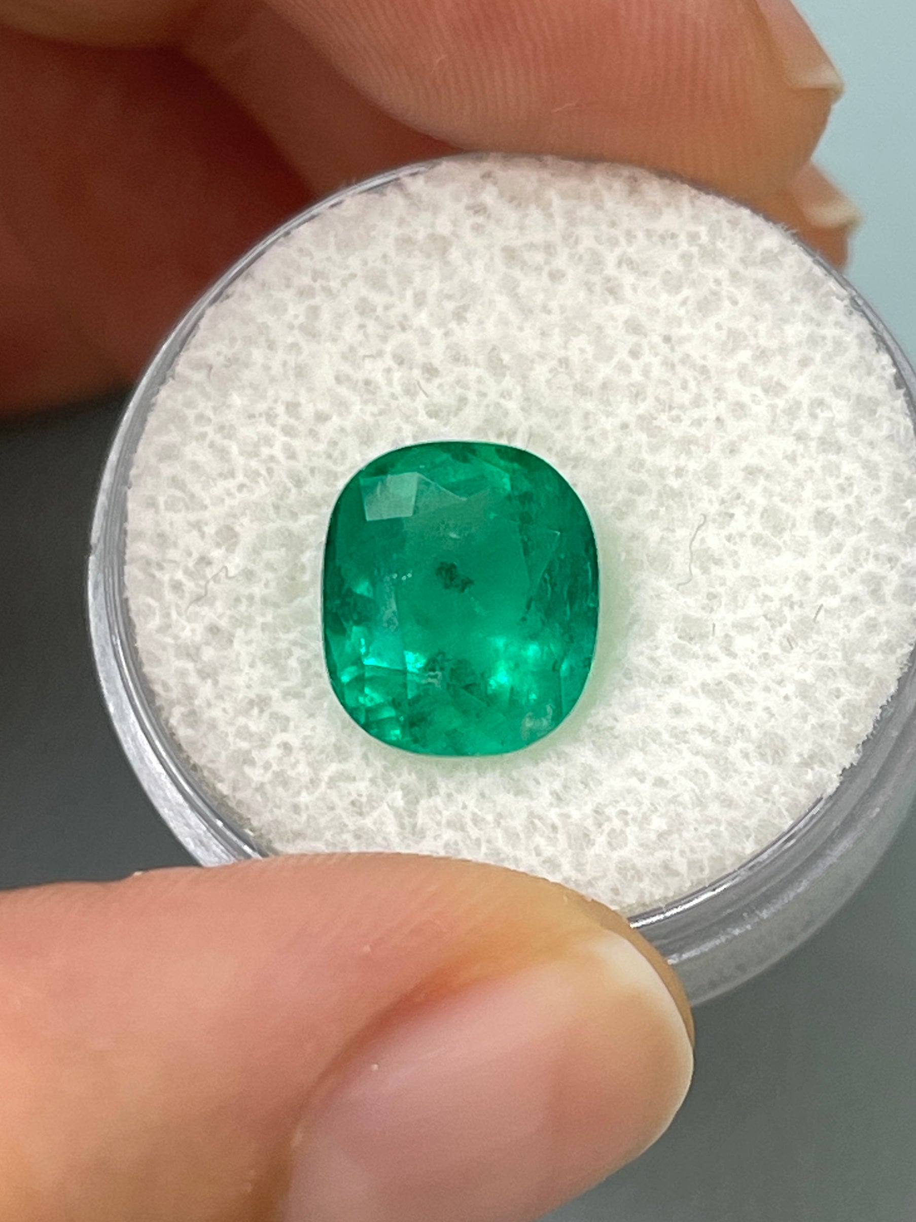 Deep green 4.37 carat natural Colombian emerald loose cushion cut gemstone with freckled surface, from JR Colombian Emeralds.