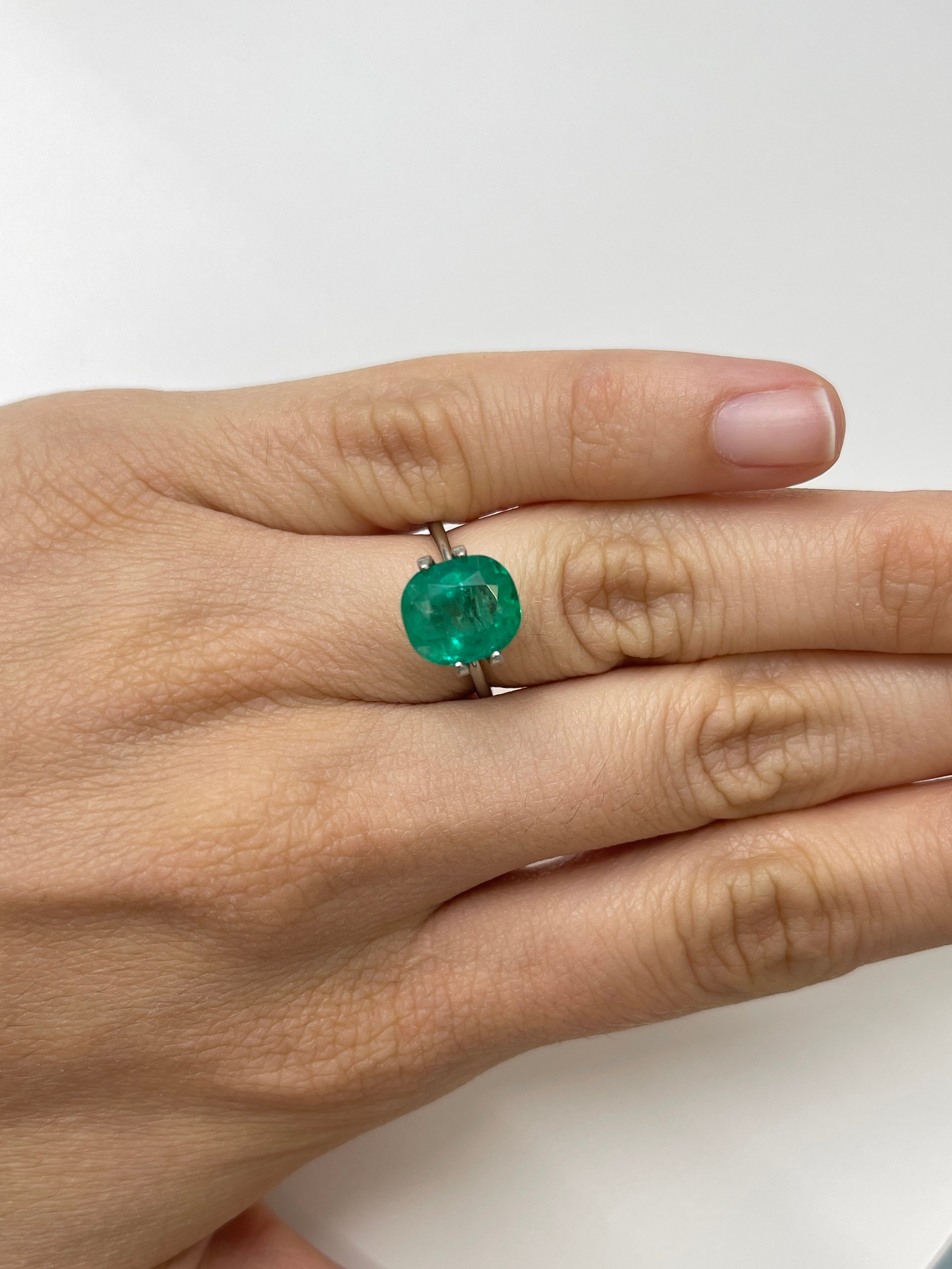 Natural loose Colombian emerald, 4.37 carats, deep green cushion cut with freckles, from JR Colombian Emeralds.