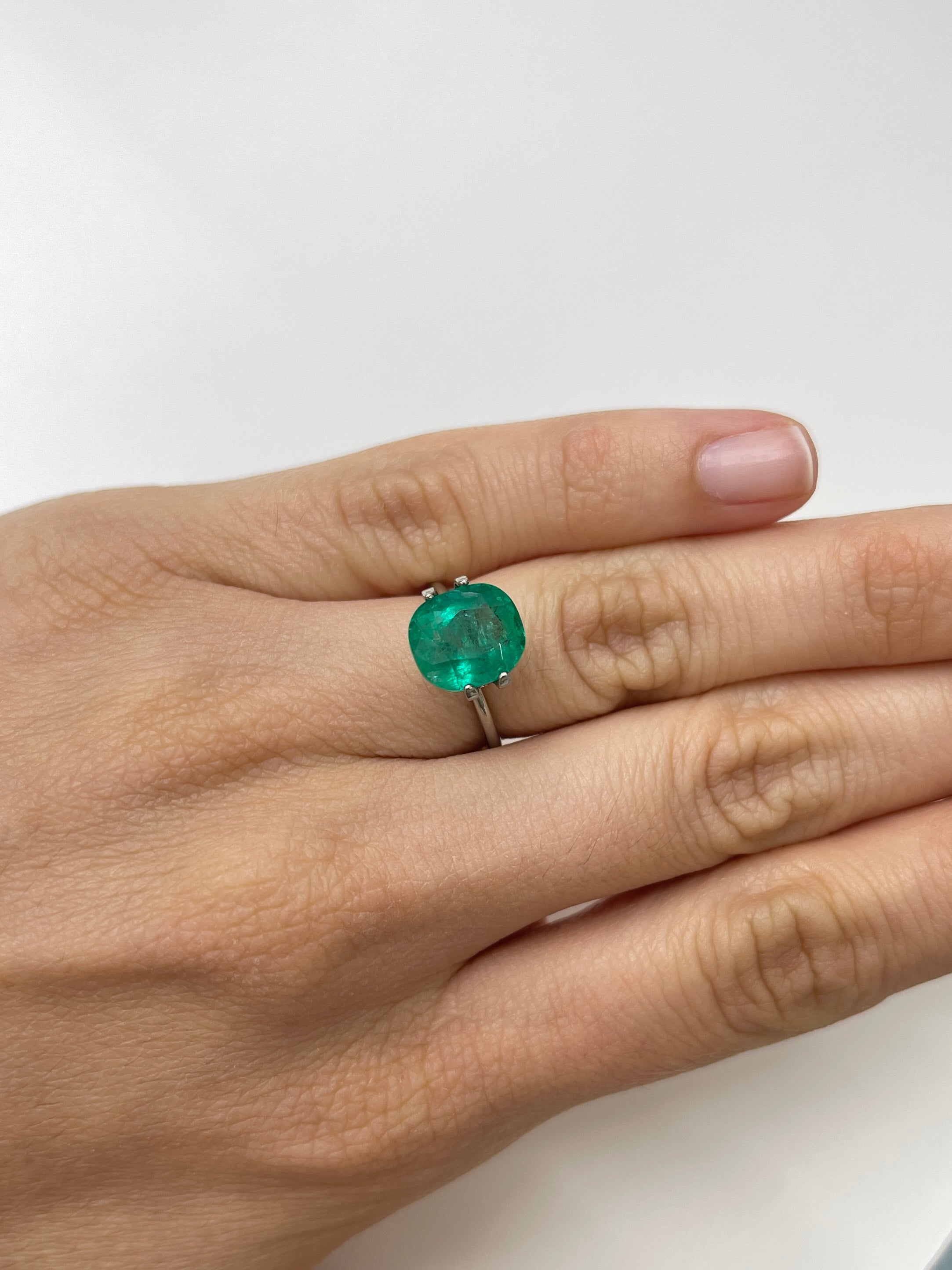 Natural loose Colombian emerald, deep green cushion cut, 4.37 carats, with natural freckles, from JR Colombian Emeralds.