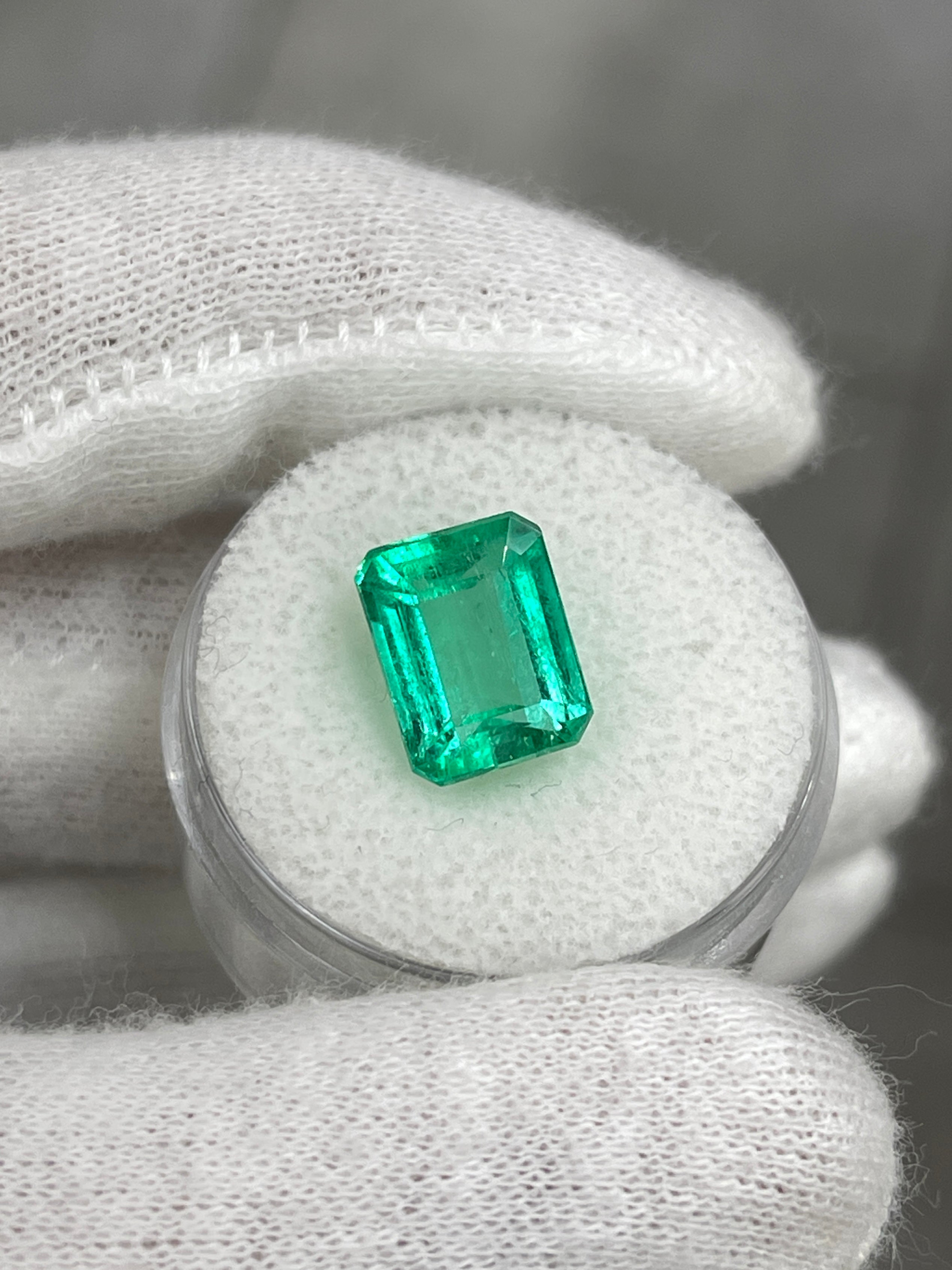 4.43 carat Jyotish green Colombian emerald loose gemstone in an emerald cut, showcasing vibrant natural green color and clarity.