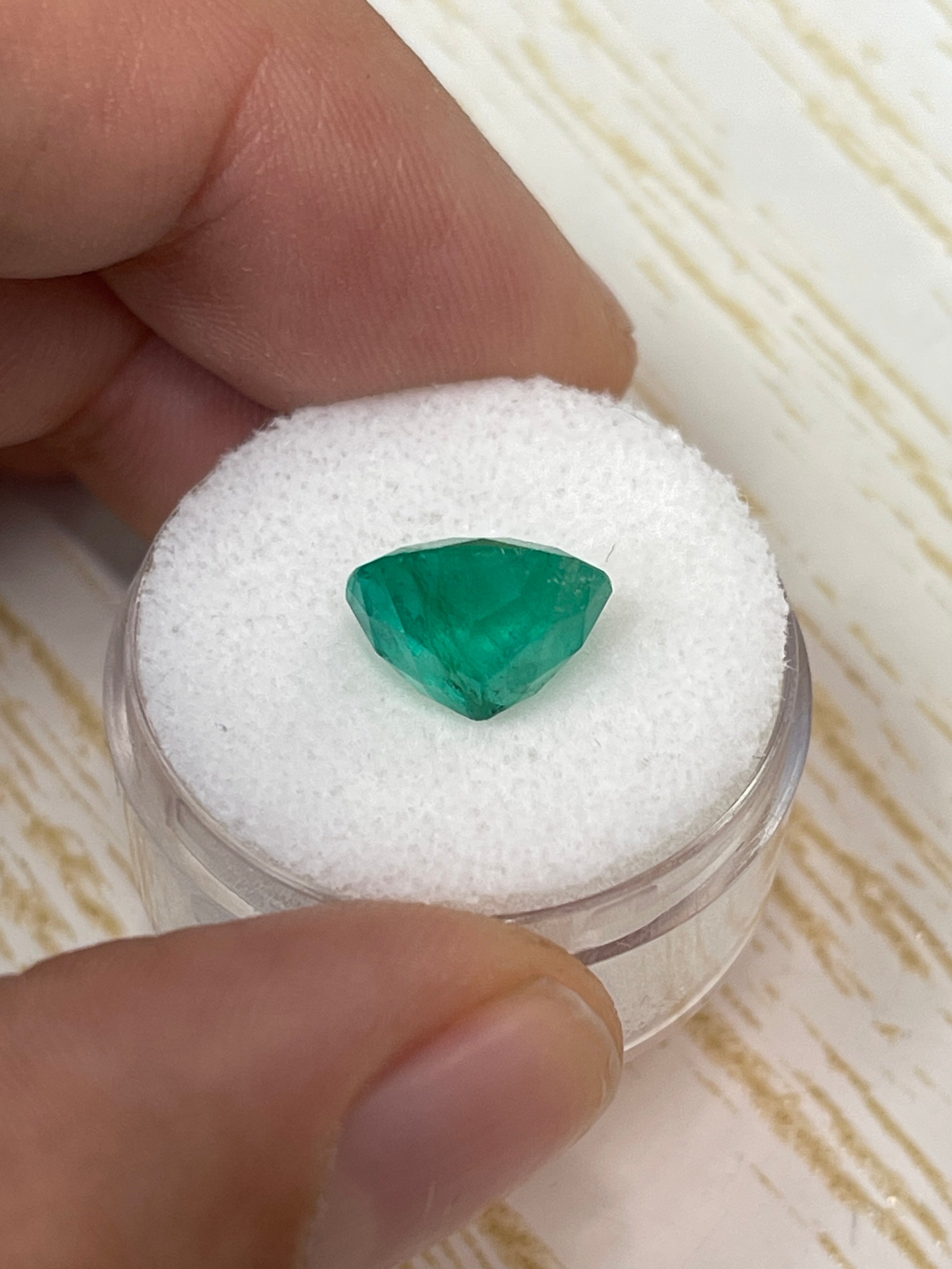 4.50 carat bluish green natural round Colombian emerald loose gemstone with vibrant color and clarity.