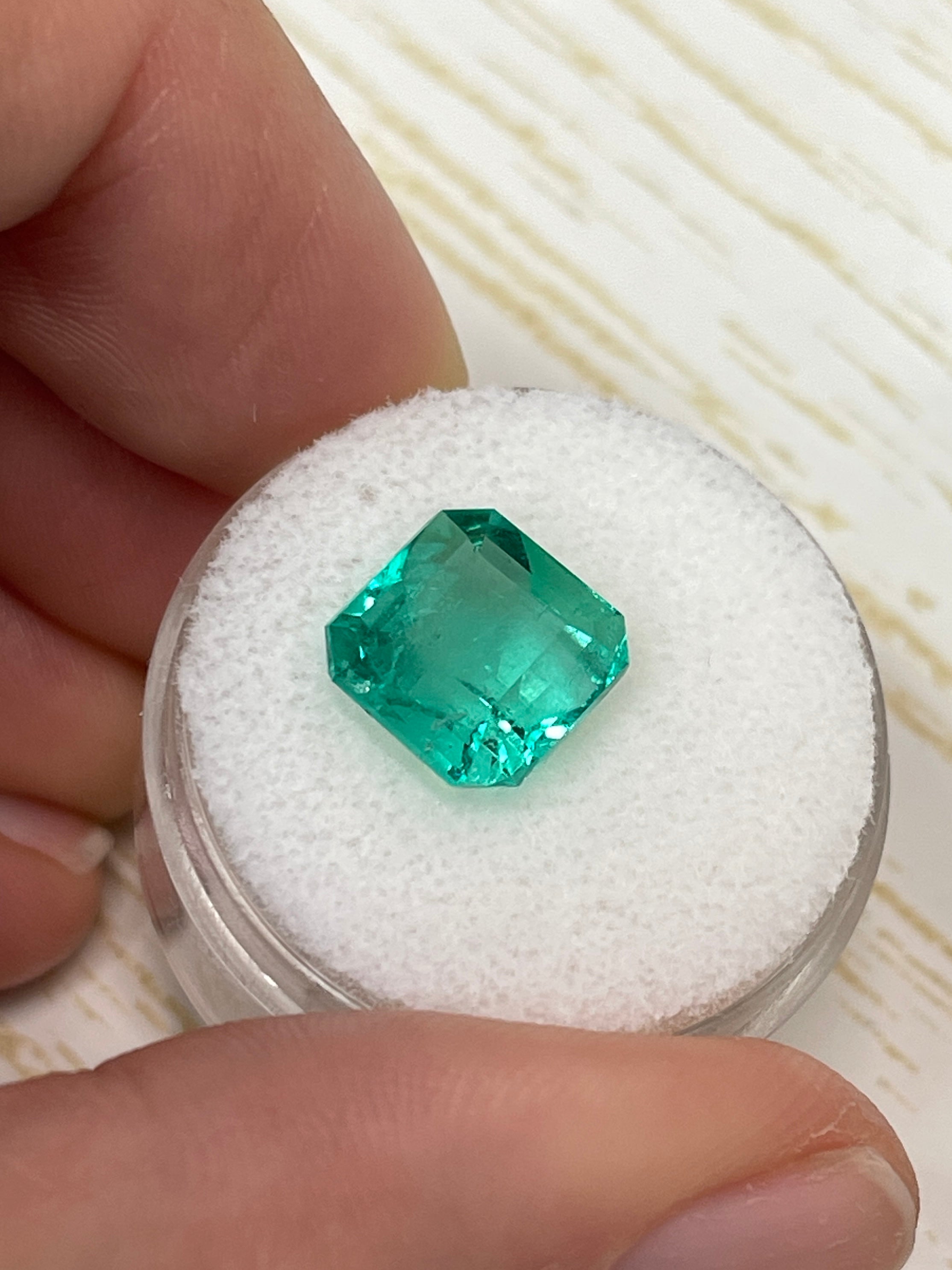 Vibrant 4.53 carat loose Colombian emerald Asscher cut gemstone from JR Colombian Emeralds, showcasing rich green color and clarity.