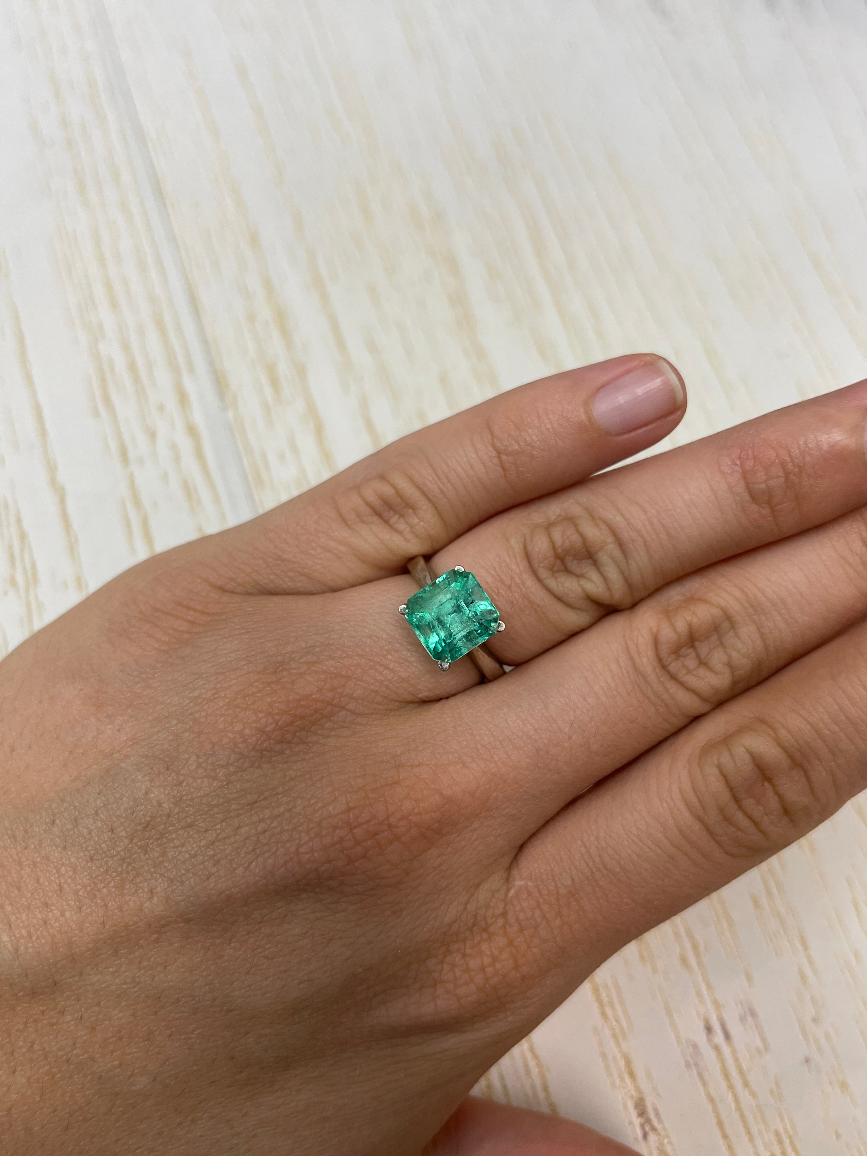 4.69 carat Colombian emerald loose gemstone, Asscher cut with clipped corners, featuring natural freckling, from JR Colombian Emeralds.