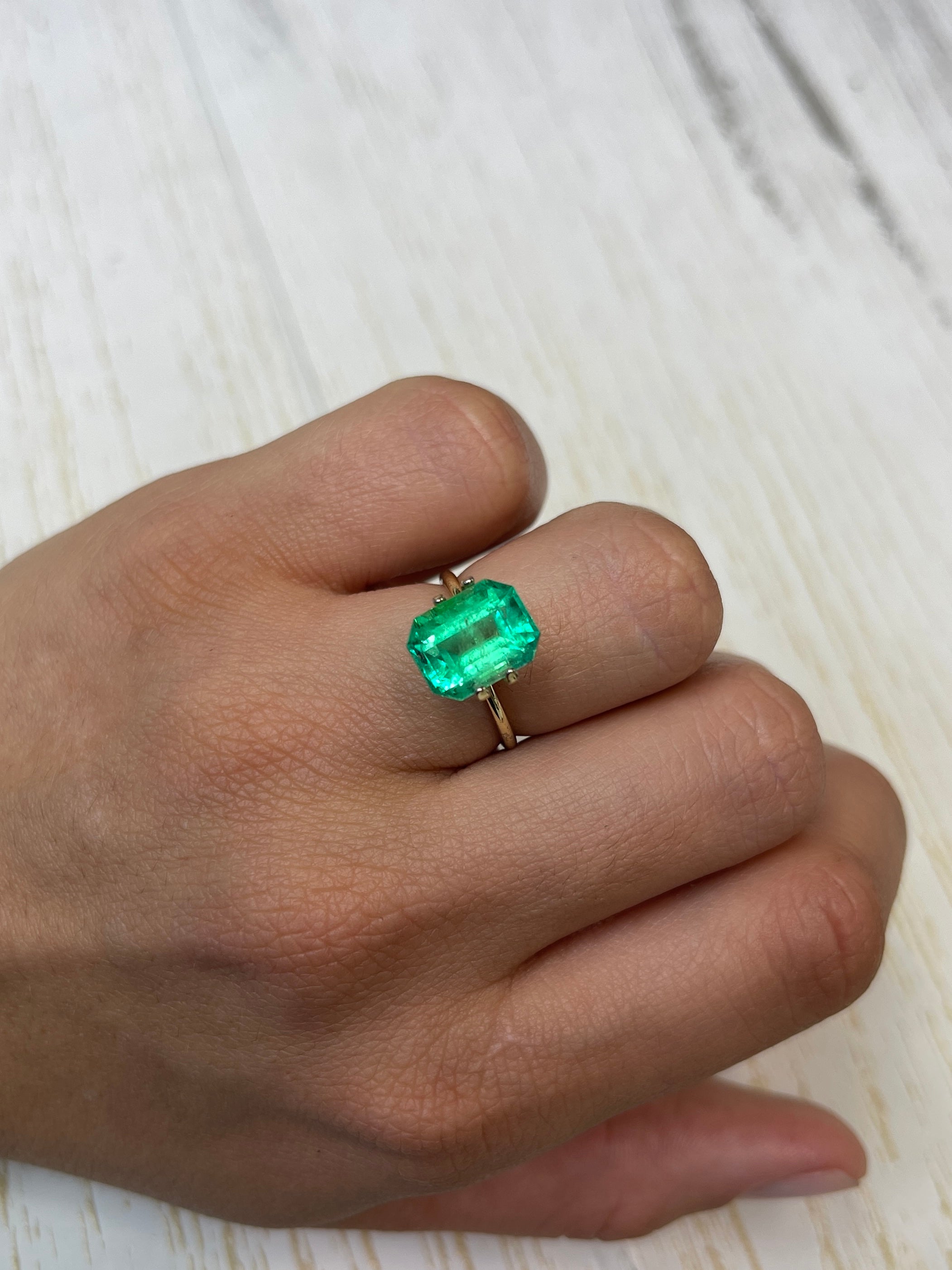 Natural 4.70 carat yellowish green Colombian emerald loose gemstone, 11x9mm classic emerald cut, from JR Colombian Emeralds.