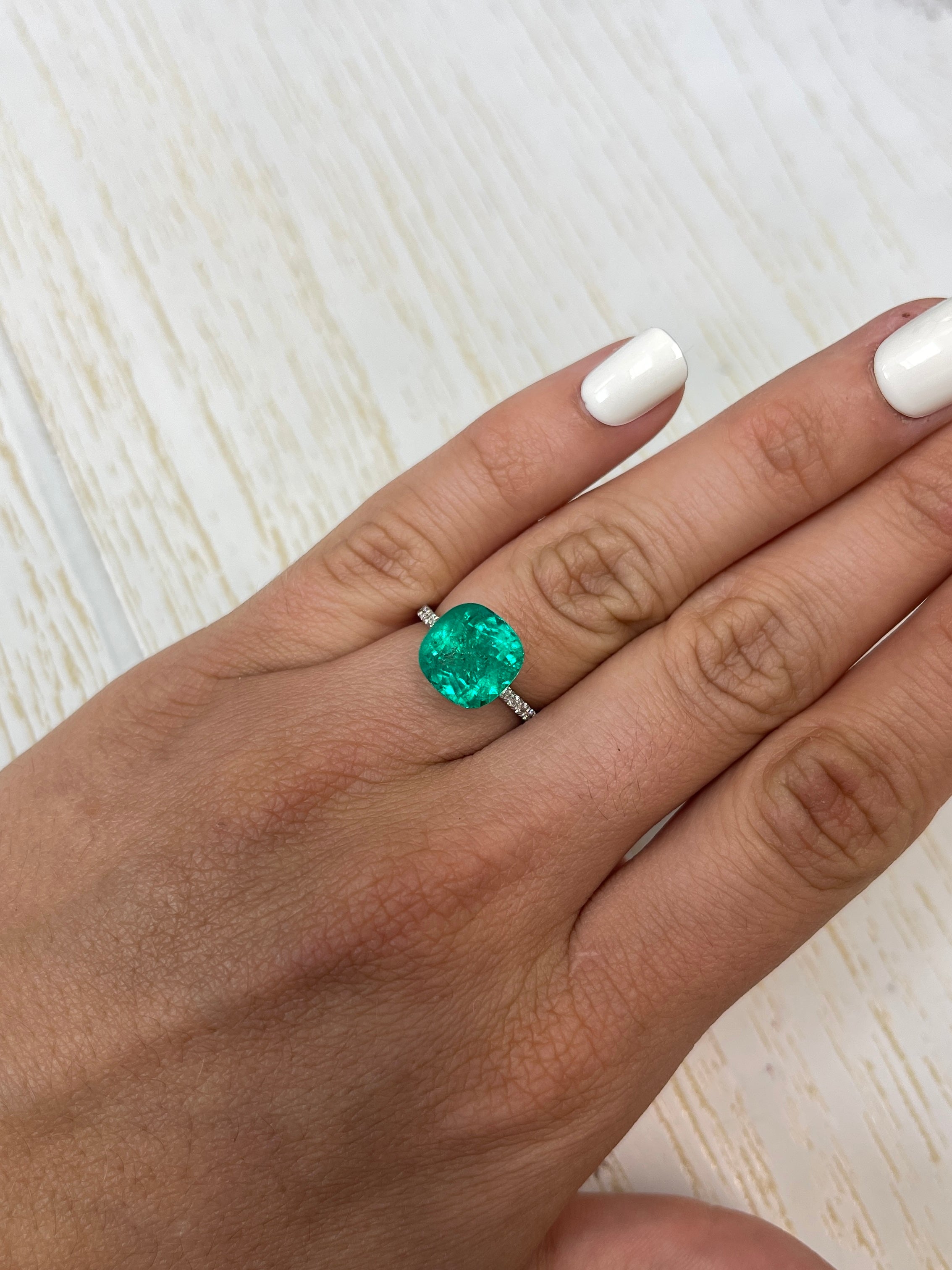 Vivid bluish green 4.75 carat natural Colombian emerald in cushion cut, loose gemstone with vibrant color and clarity.