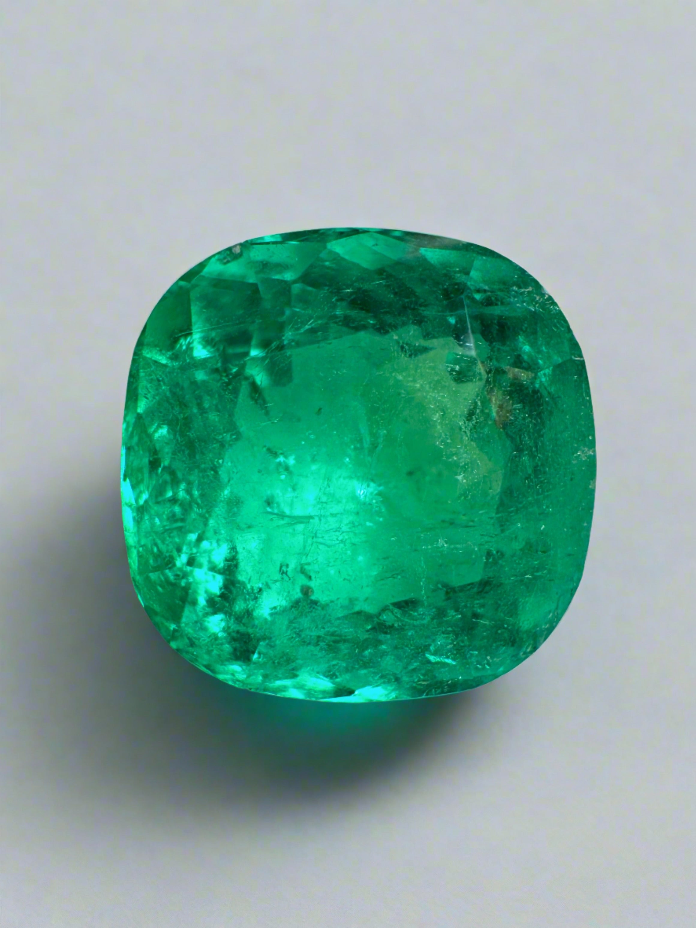 Vivid bluish green 4.75 carat natural Colombian emerald in cushion cut, loose gemstone showcasing vibrant color and clarity.