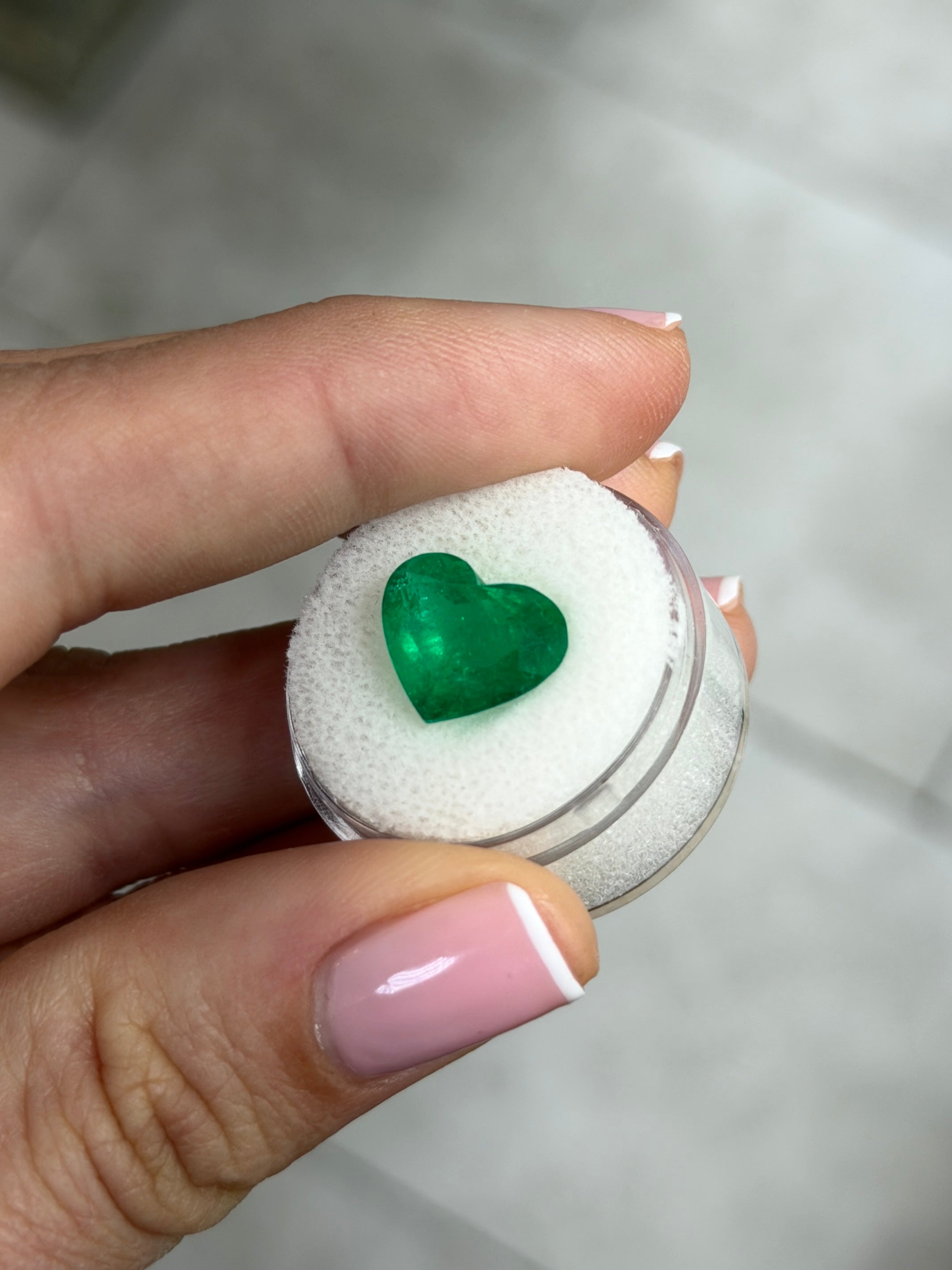 4.79 carat 11x13mm AAA+ intense green natural Colombian emerald loose gemstone in heart cut, showcasing vibrant color and clarity.