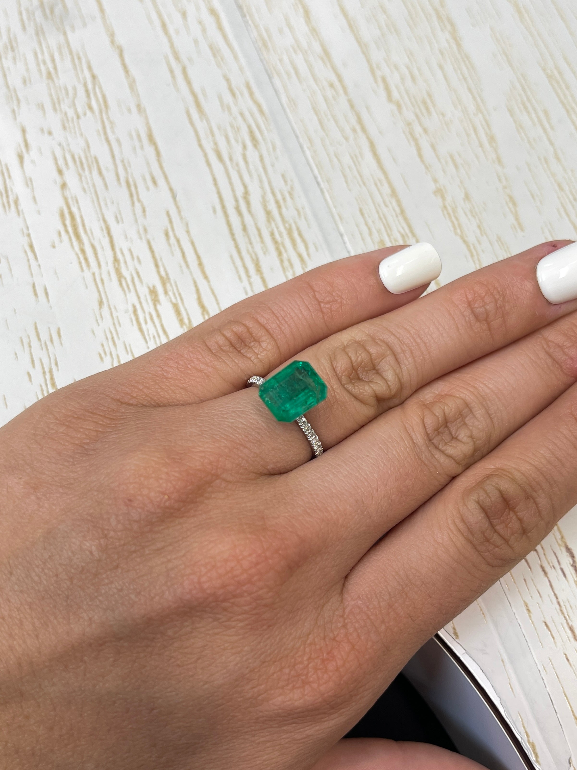 4.81 carat medium green natural Zambian emerald cut loose gemstone, showcasing vibrant color and clarity.