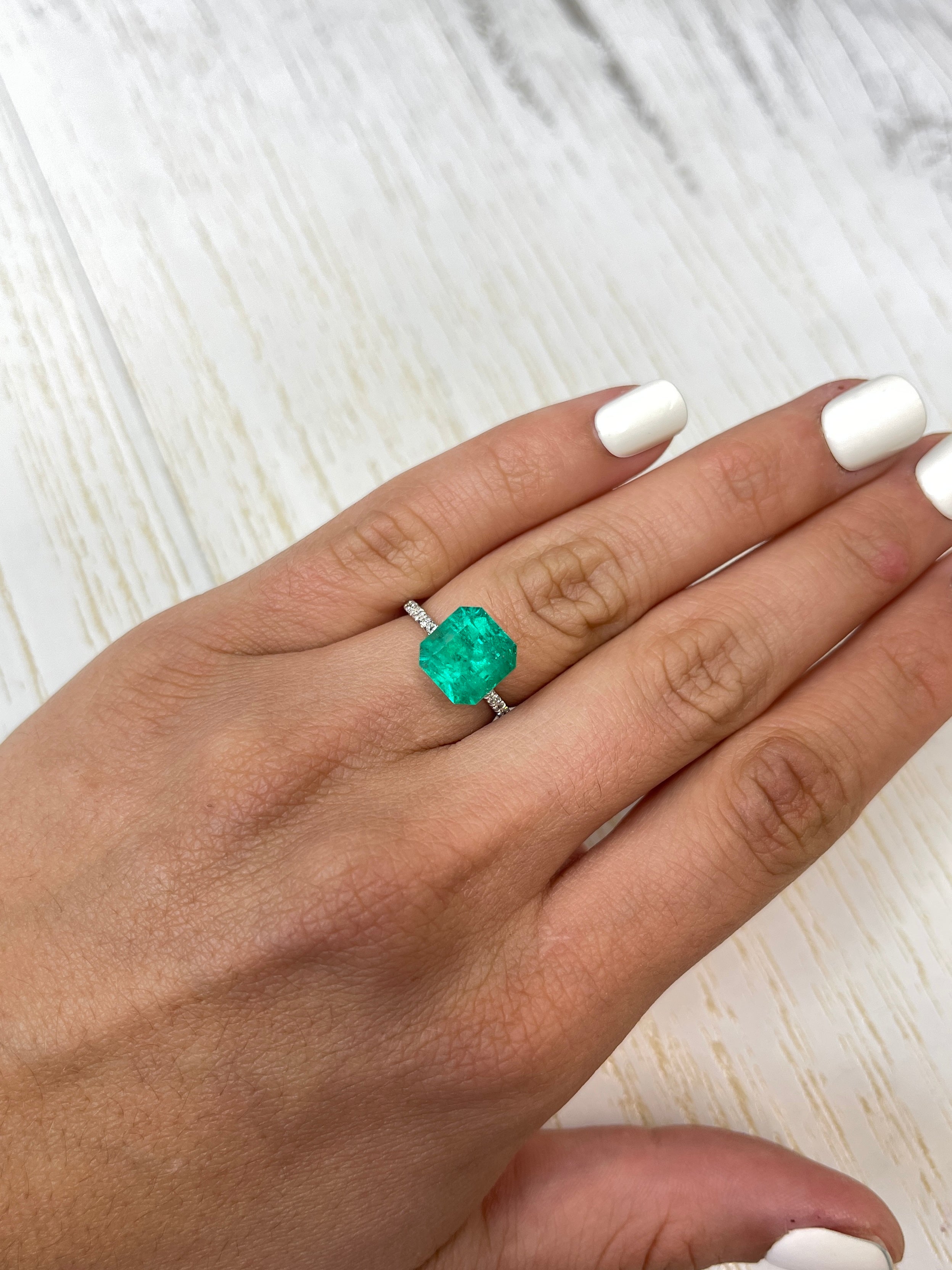 Vibrant 4.83 carat 10x10mm loose Colombian emerald in an Asscher cut, showcased by JR Colombian Emeralds.