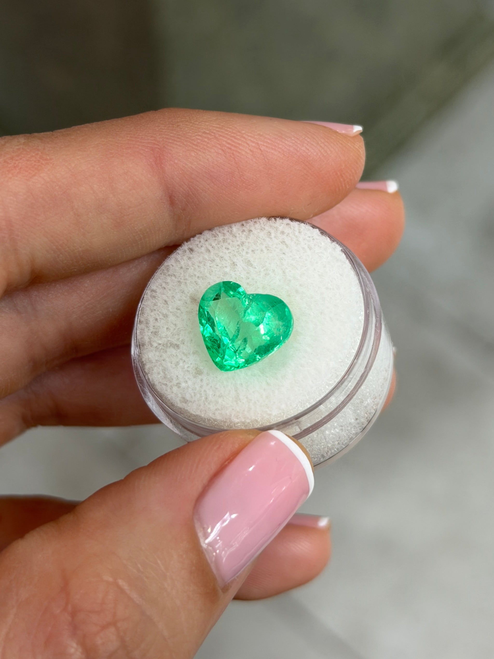 Natural loose Colombian emerald, 4.83 carats, 10x11mm heart cut with glowing electric green color, from JR Colombian Emeralds.