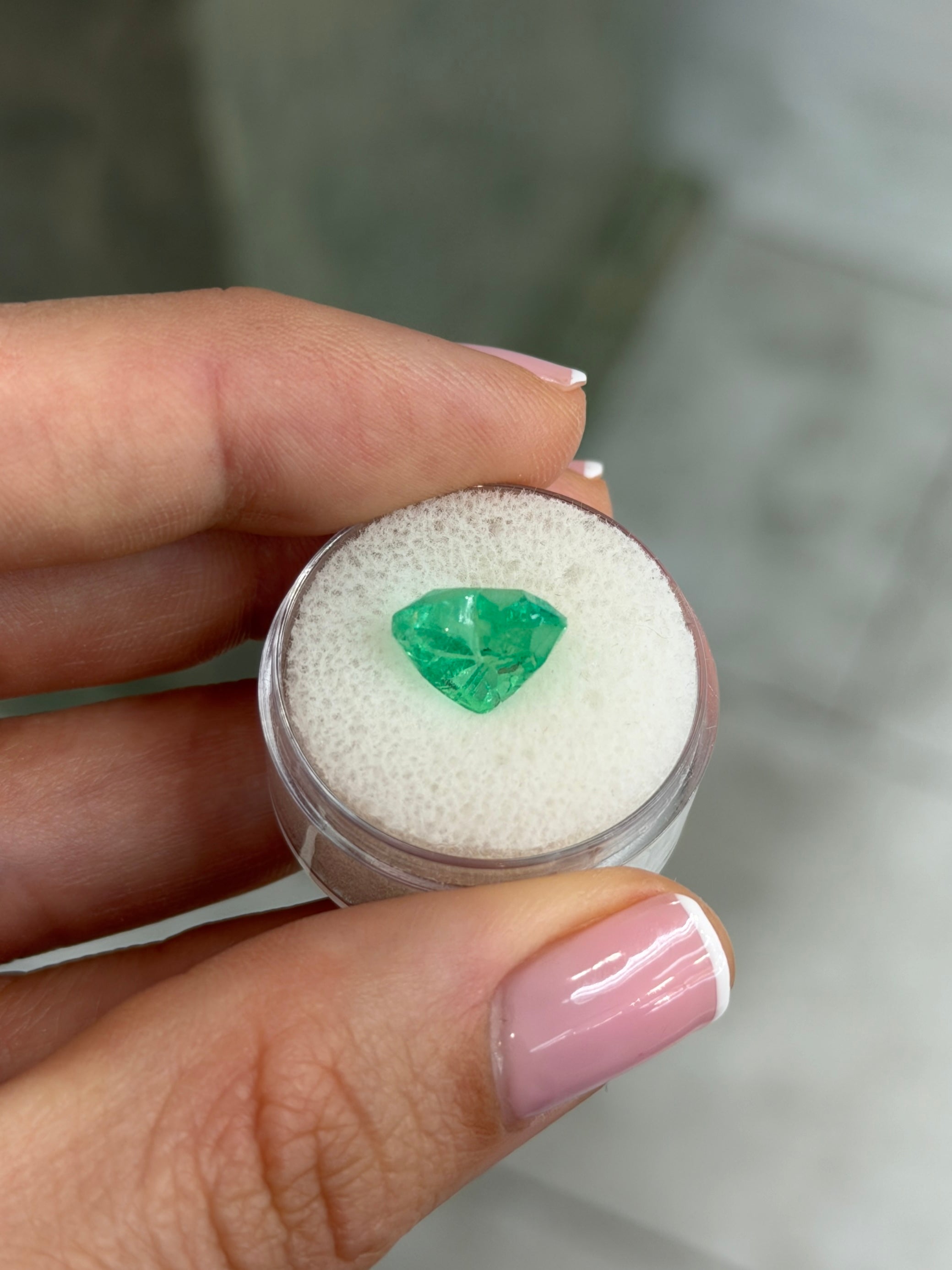 Electric green 4.83 carat natural Colombian emerald in heart cut, glowing with vibrant color, from JR Colombian Emeralds.