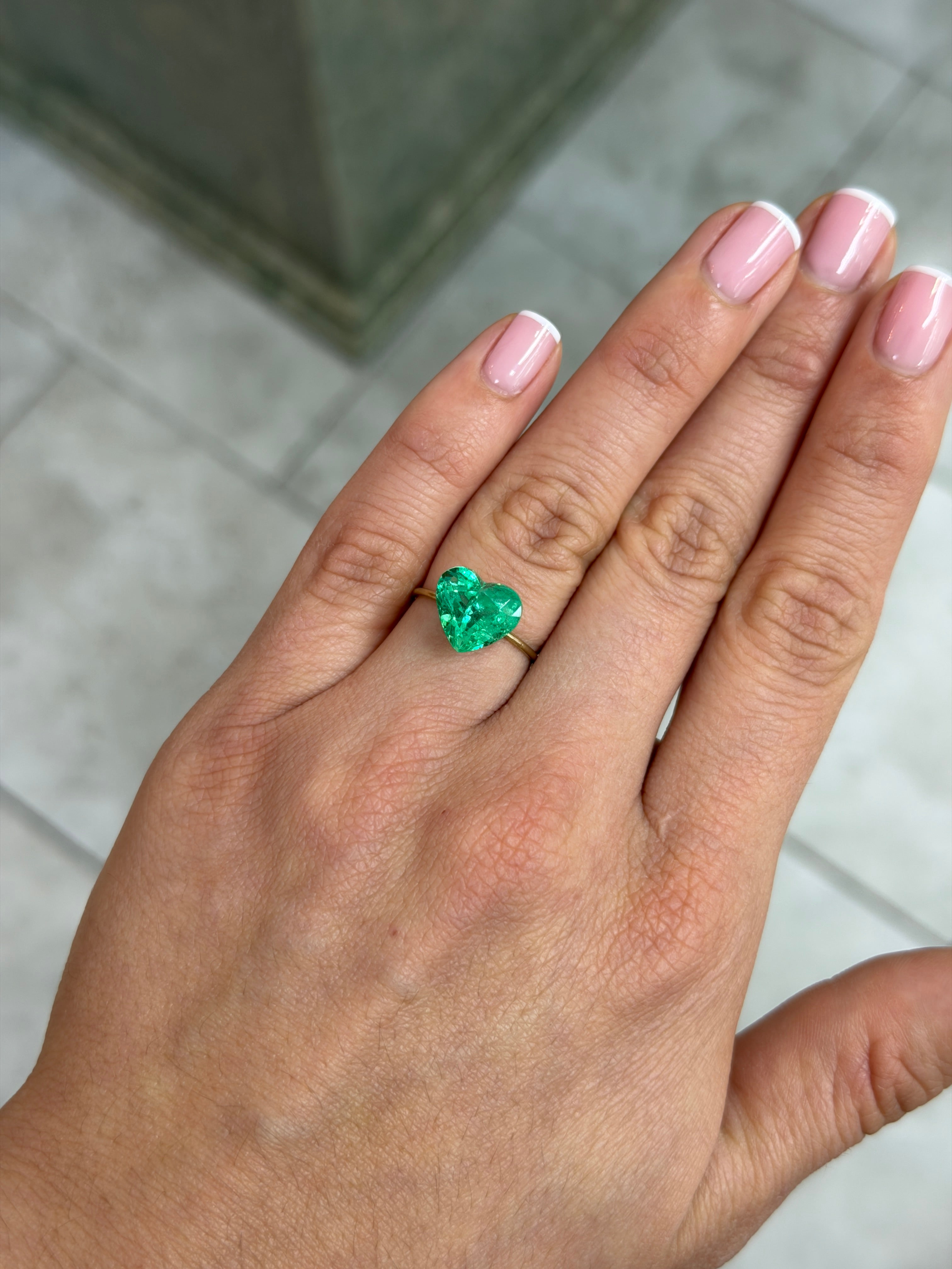 Natural loose Colombian emerald, 4.83 carats, 10x11 mm heart cut, glowing electric green, from JR Colombian Emeralds.