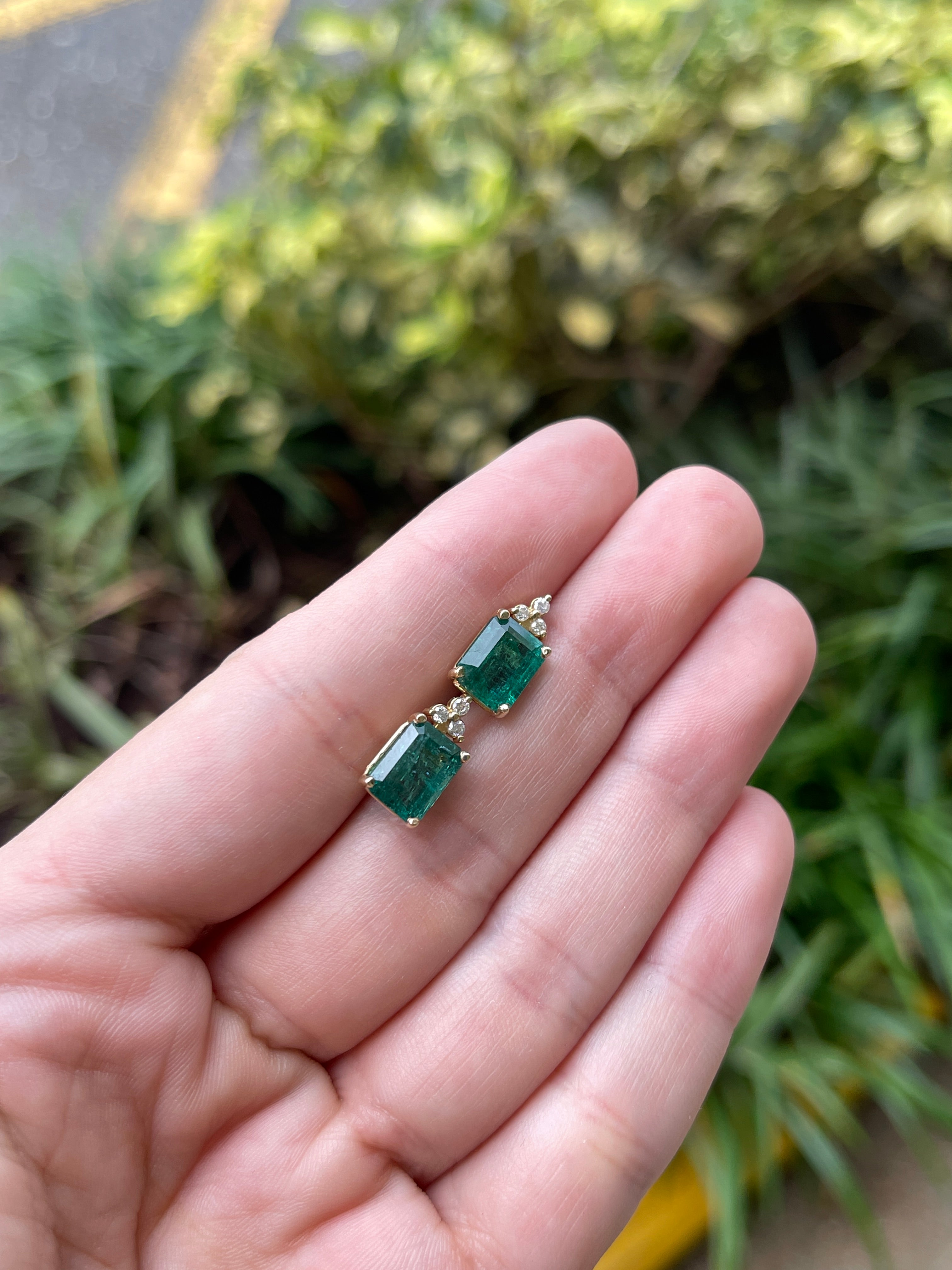 14K gold stud earrings featuring rich green emeralds and diamond accents, designed by JR Colombian Emeralds.