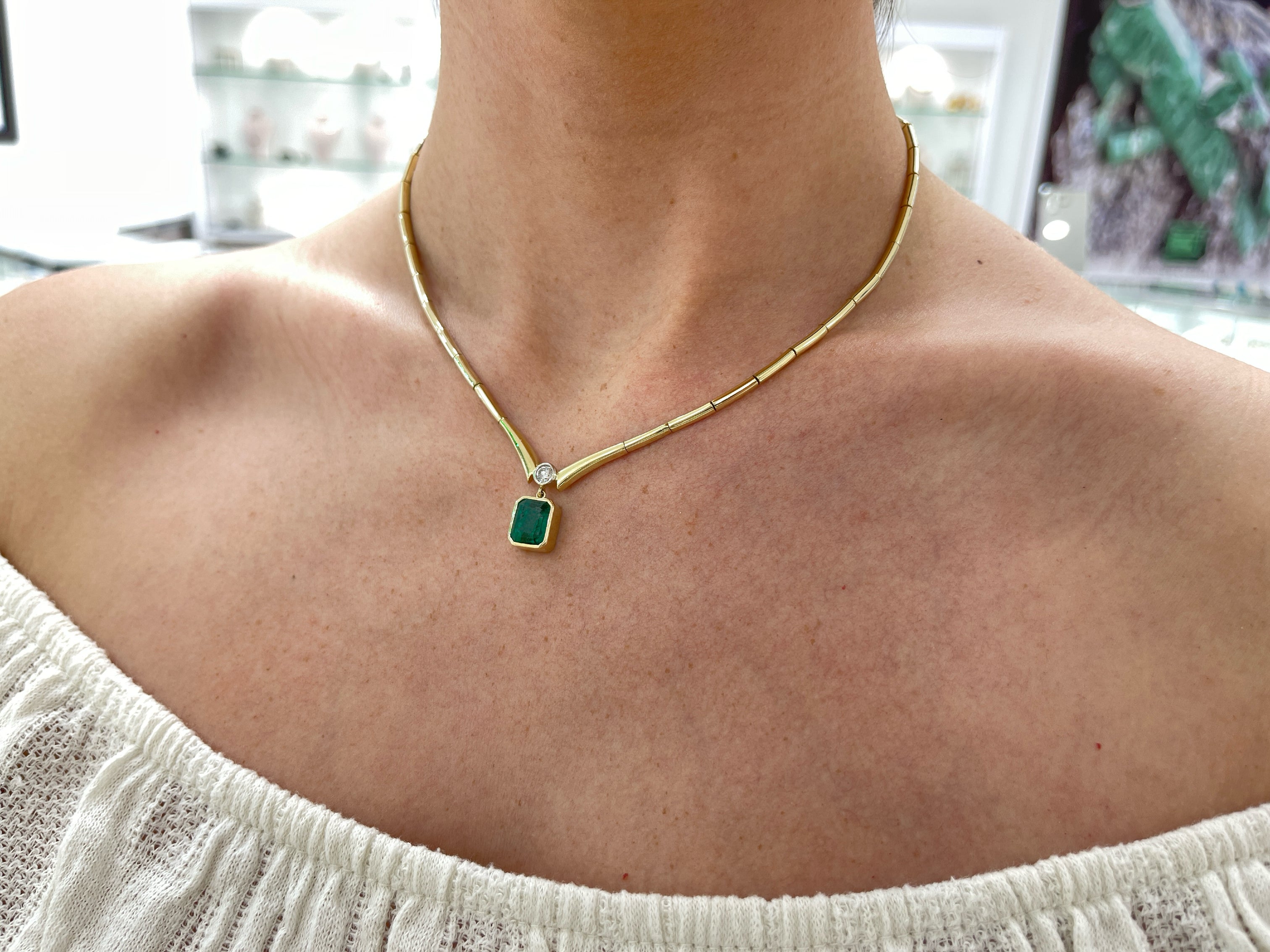 14K gold Toi Et Moi necklace featuring bezel-set emerald and diamond accents, crafted by JR Colombian Emeralds.