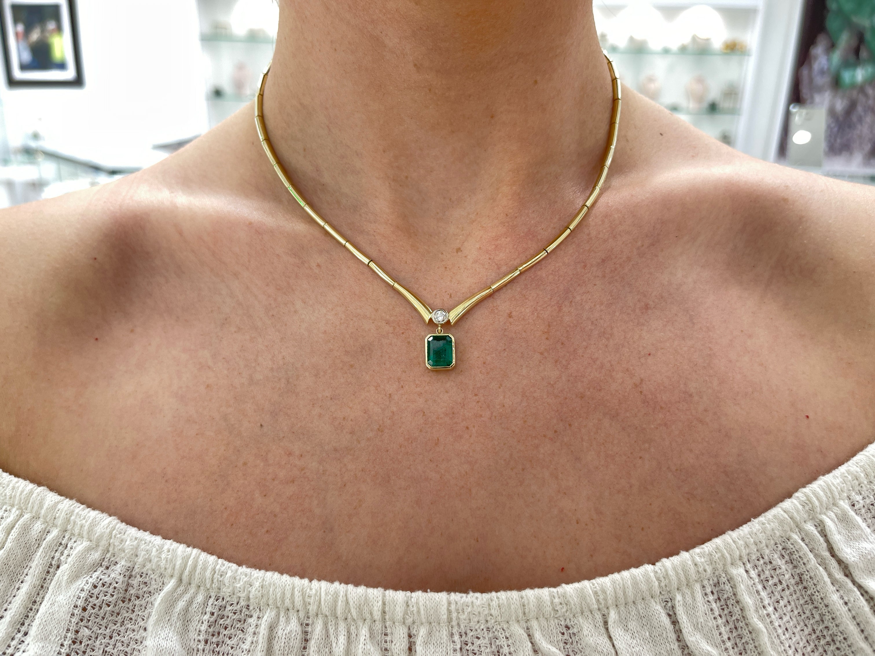 14K gold Toi Et Moi necklace featuring bezel-set emerald and diamond accents, crafted by JR Colombian Emeralds.