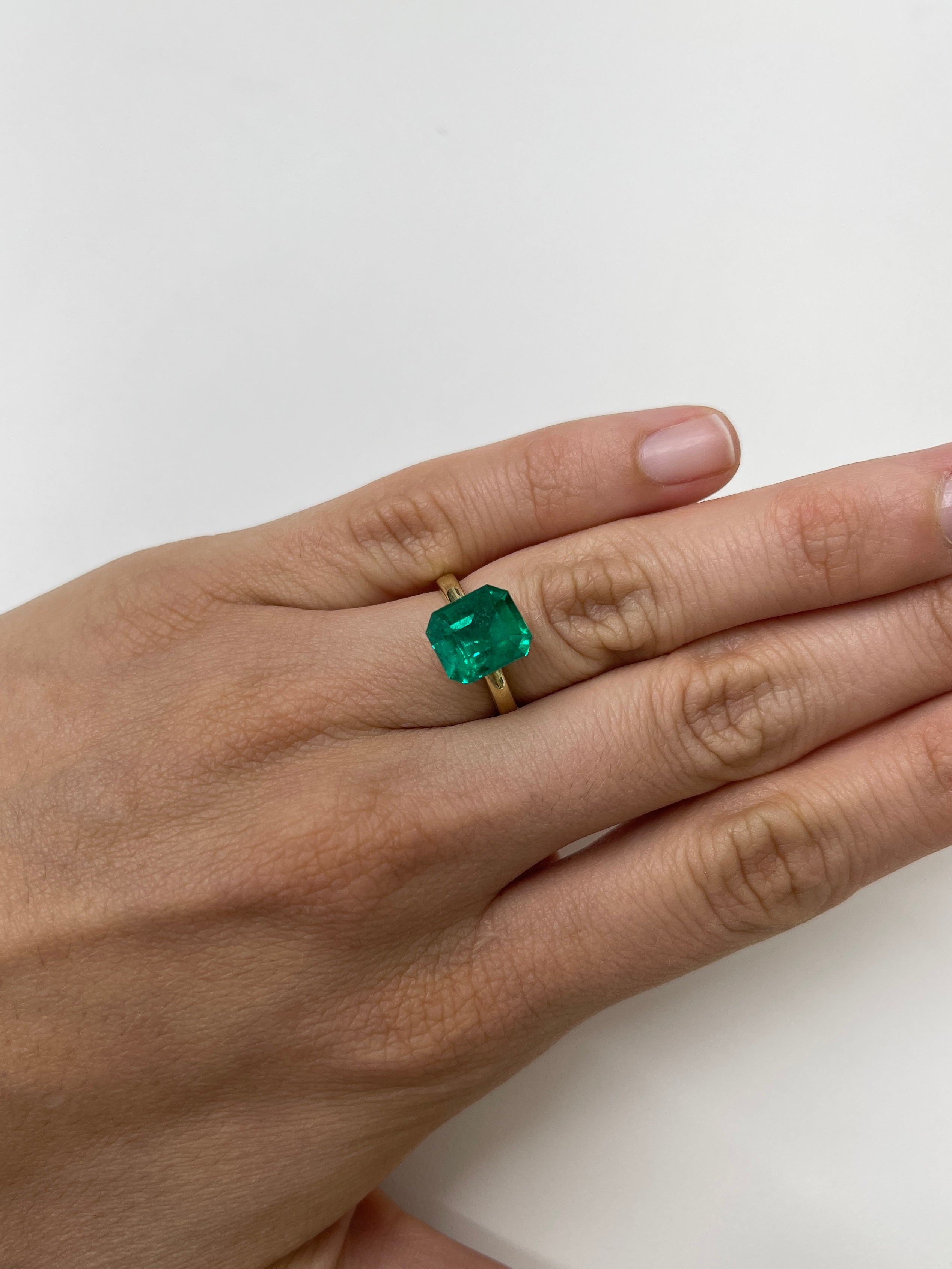 Natural 4.93 carat Colombian emerald cut loose gemstone from JR Colombian Emeralds, AAA+ investment grade, vivid green color.