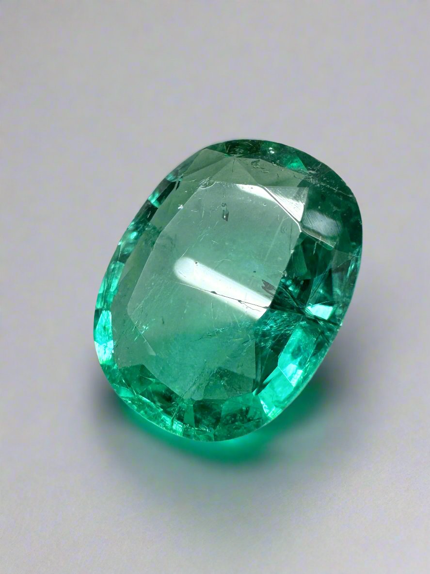 Natural 5.09 carat Zambian emerald loose gemstone in cushion and oval cut with bubbly hybrid cut, from JR Colombian Emeralds.