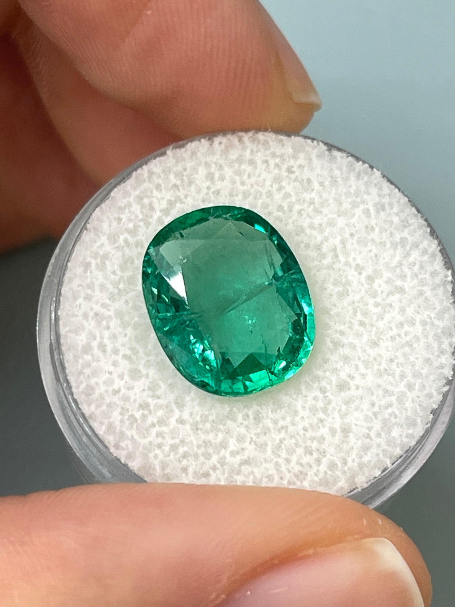 5.09 carat natural Zambian emerald loose gemstone with bubbly hybrid cushion and oval cut, from JR Colombian Emeralds.