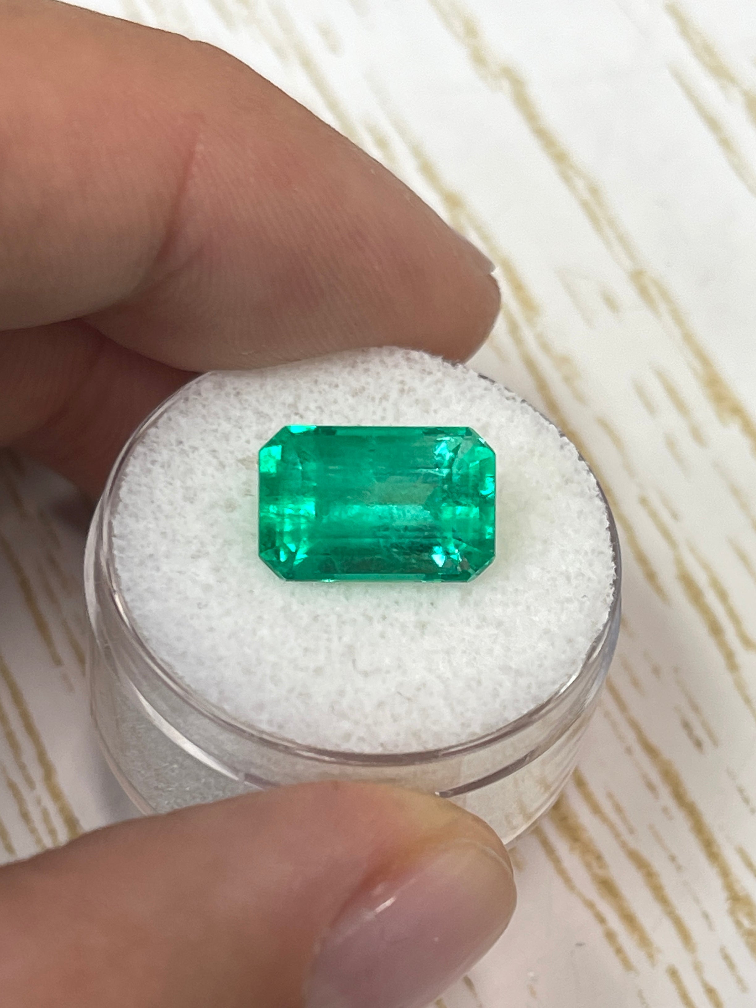 Yellowish green 5.26 carat natural Colombian emerald loose gemstone in an emerald cut, polished and faceted.