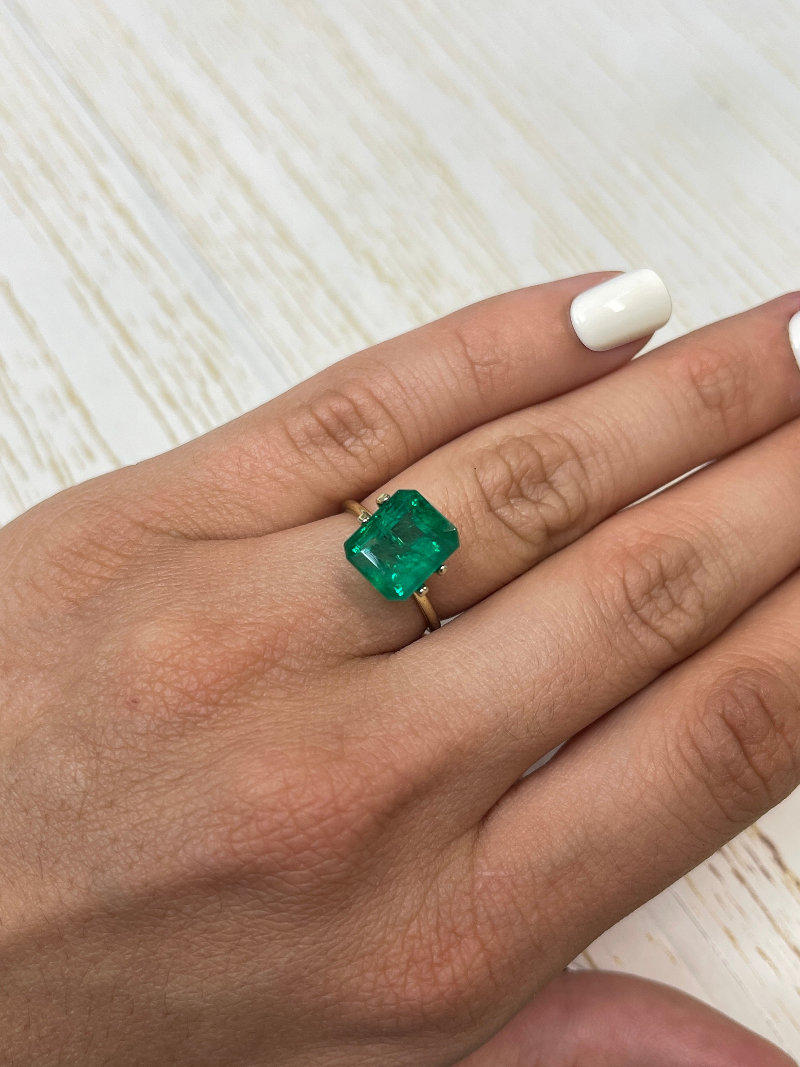 Natural 5.32 carat Zambian emerald cut loose emerald from JR Colombian Emeralds, vivid Kelly green, transparent, and finely faceted.