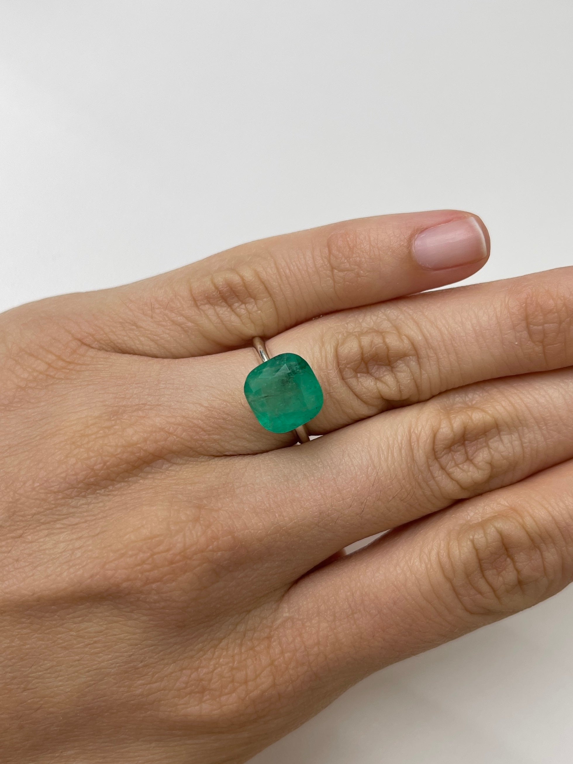 Natural 5.33 carat Colombian emerald loose cushion cut with earthy green tones, from JR Colombian Emeralds.