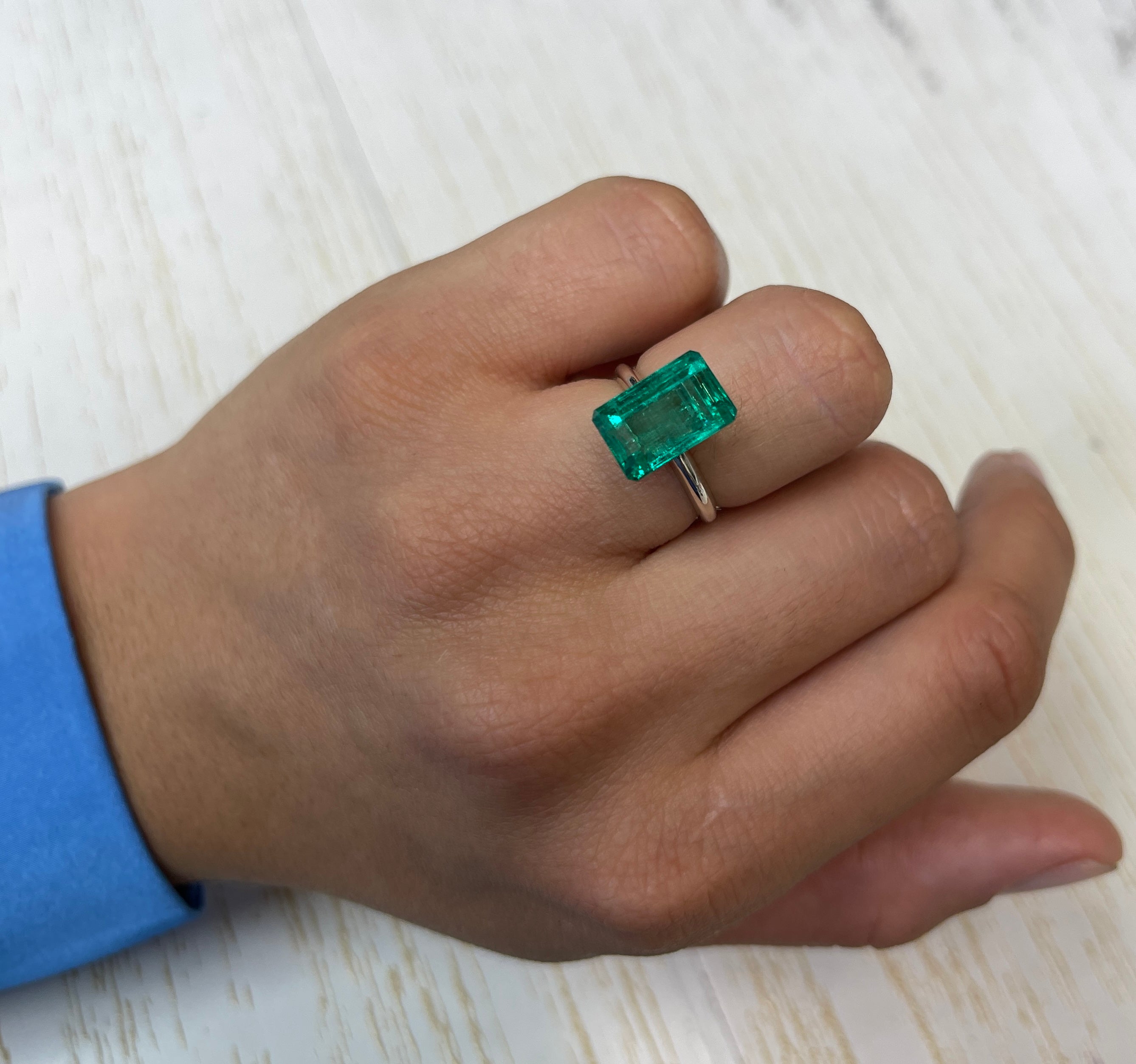 5.63 carat 13x8mm VS bluish green natural Colombian emerald loose gemstone in an emerald cut shape.