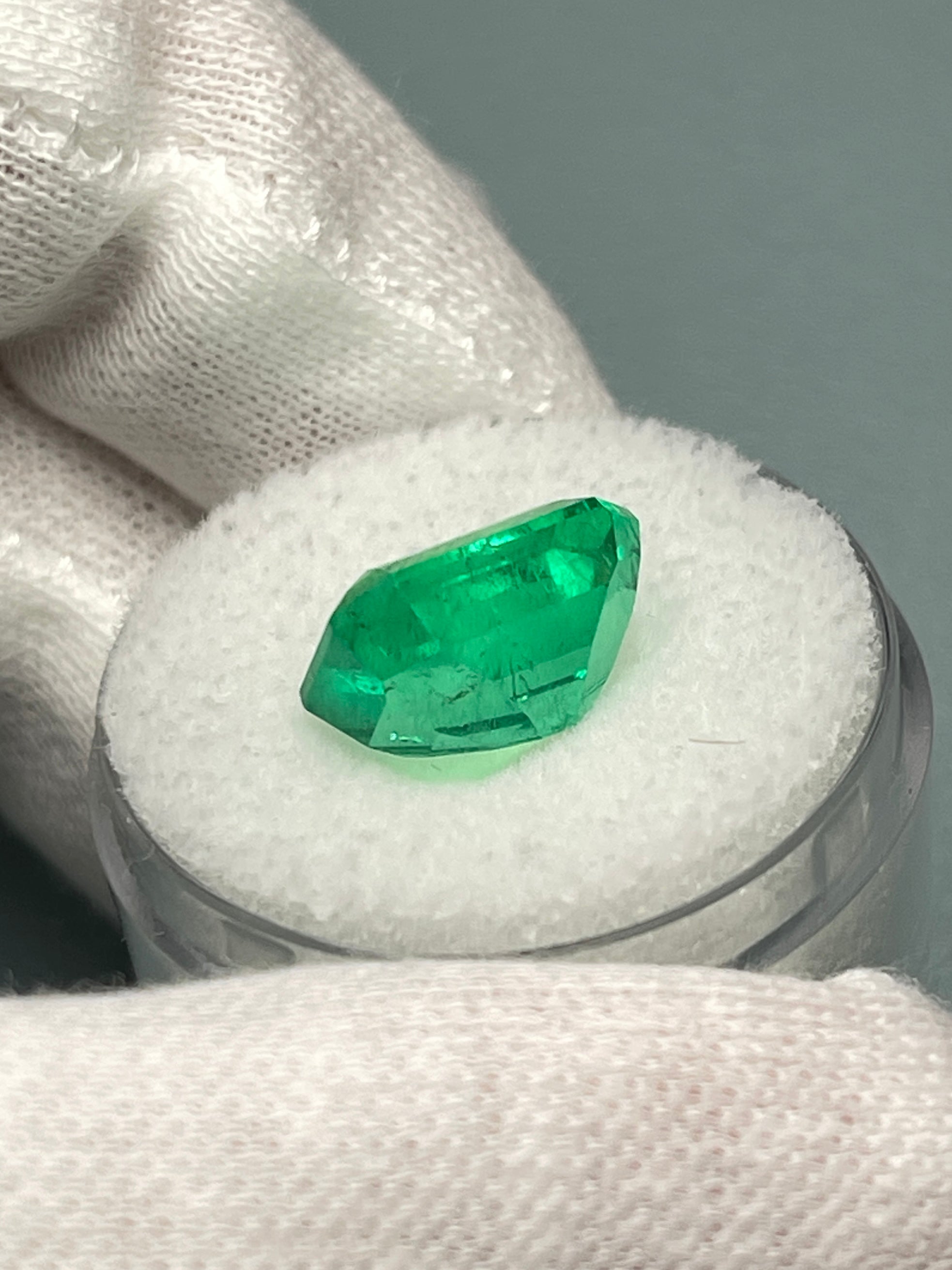 Vivid 5.71 carat Muzo green Colombian emerald loose gemstone in classic emerald cut, natural and vibrant.