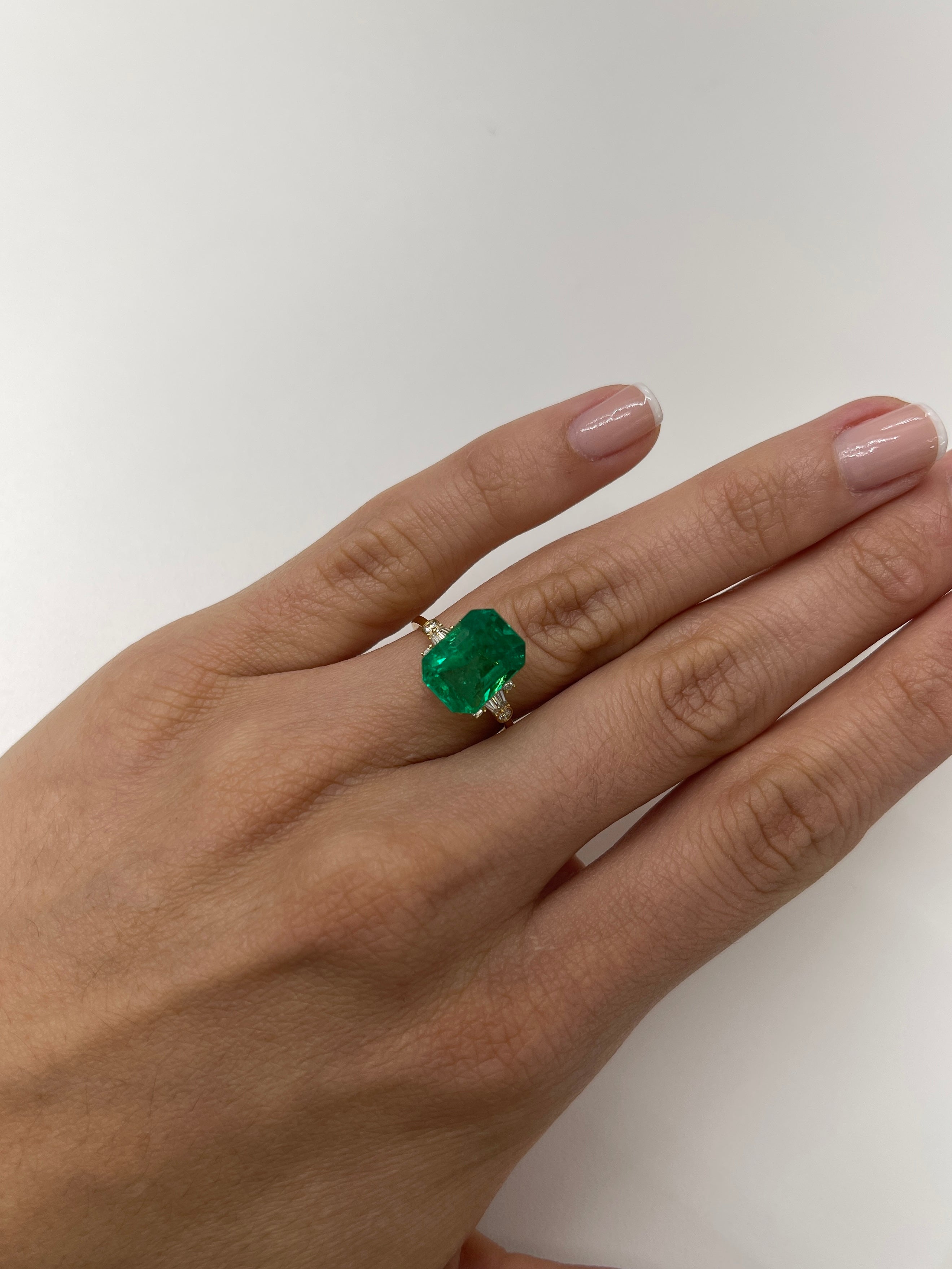 Vivid 5.71 carat Muzo green Colombian emerald loose gemstone in classic emerald cut, from JR Colombian Emeralds.