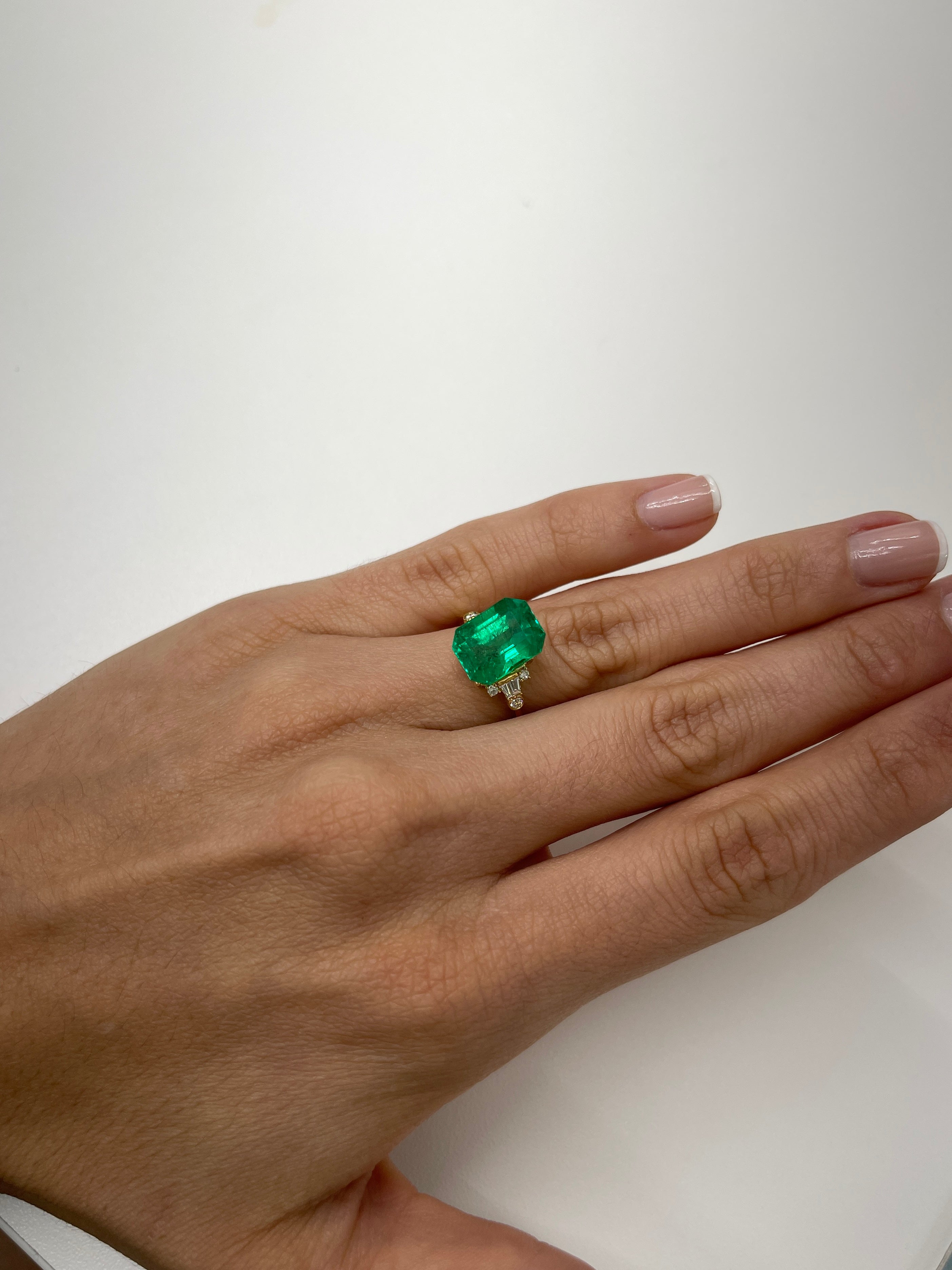 Vivid 5.71 carat Muzo green Colombian emerald loose gemstone, 12x9 mm classic emerald cut, natural and vibrant.