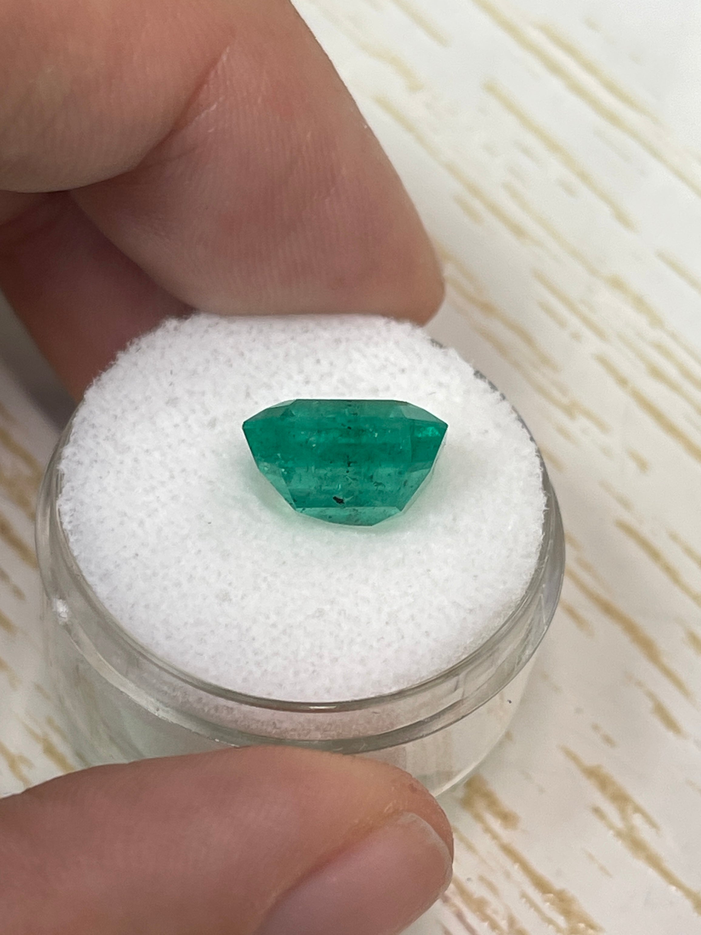 Natural 5.72 carat Colombian emerald, 11x10.5mm Asscher cut, featuring unique freckled forest green color, by JR Colombian Emeralds