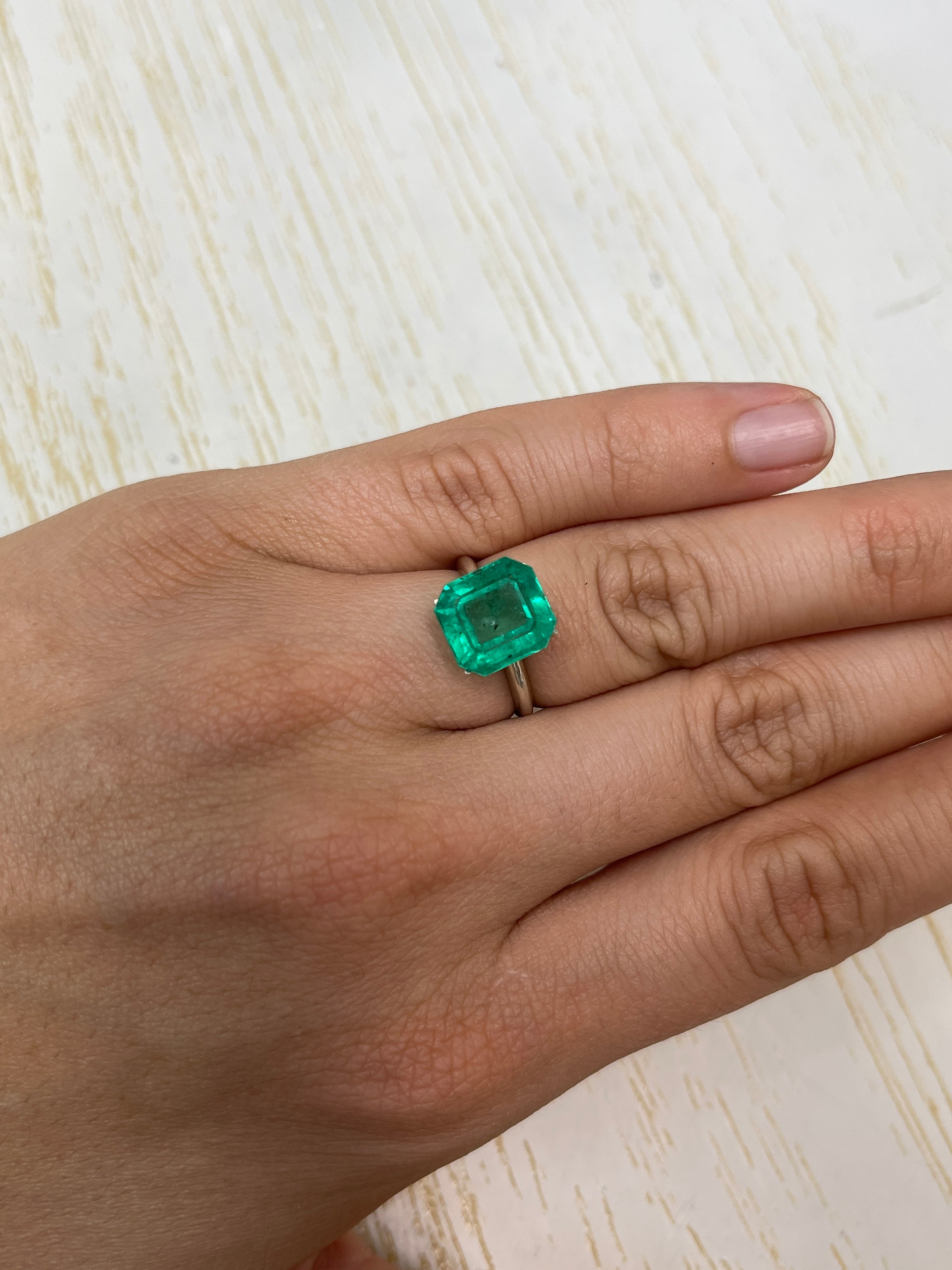 Natural 5.72 carat Colombian emerald loose Asscher cut with freckled forest green color by JR Colombian Emeralds.