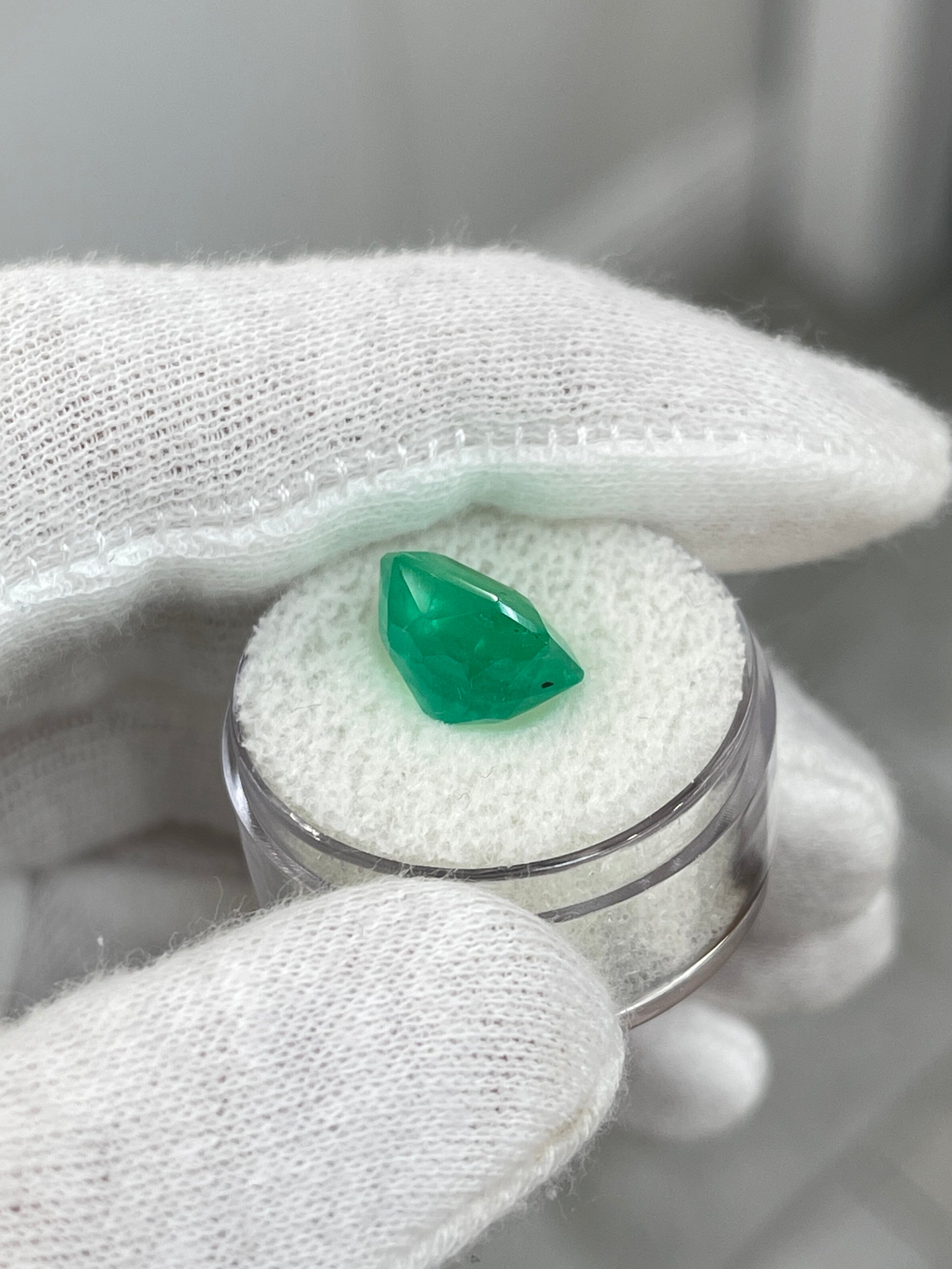 Freckled medium green 5.75 carat Colombian emerald loose gemstone in emerald cut, natural and radiant from JR Colombian Emeralds.